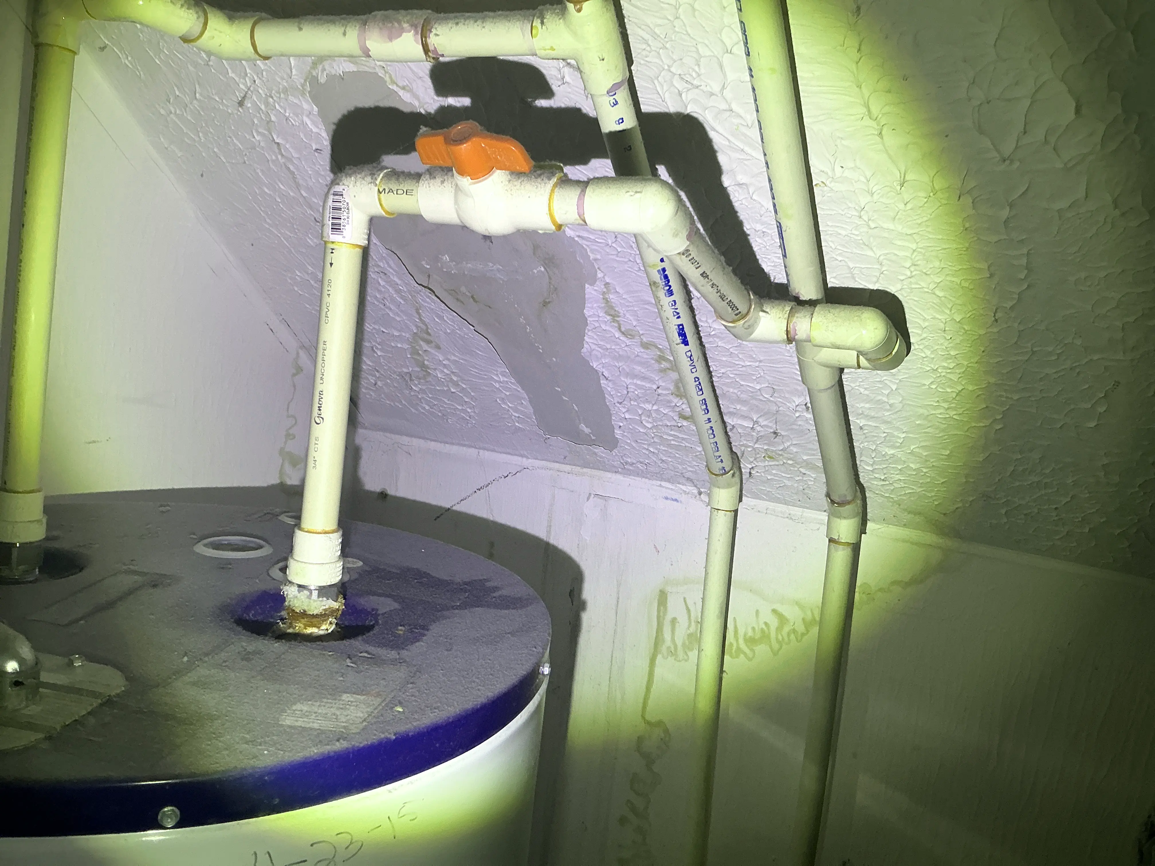 Corrosion on water heater pipe connection with ceiling water damage during indoor air quality testing 2026-07-19