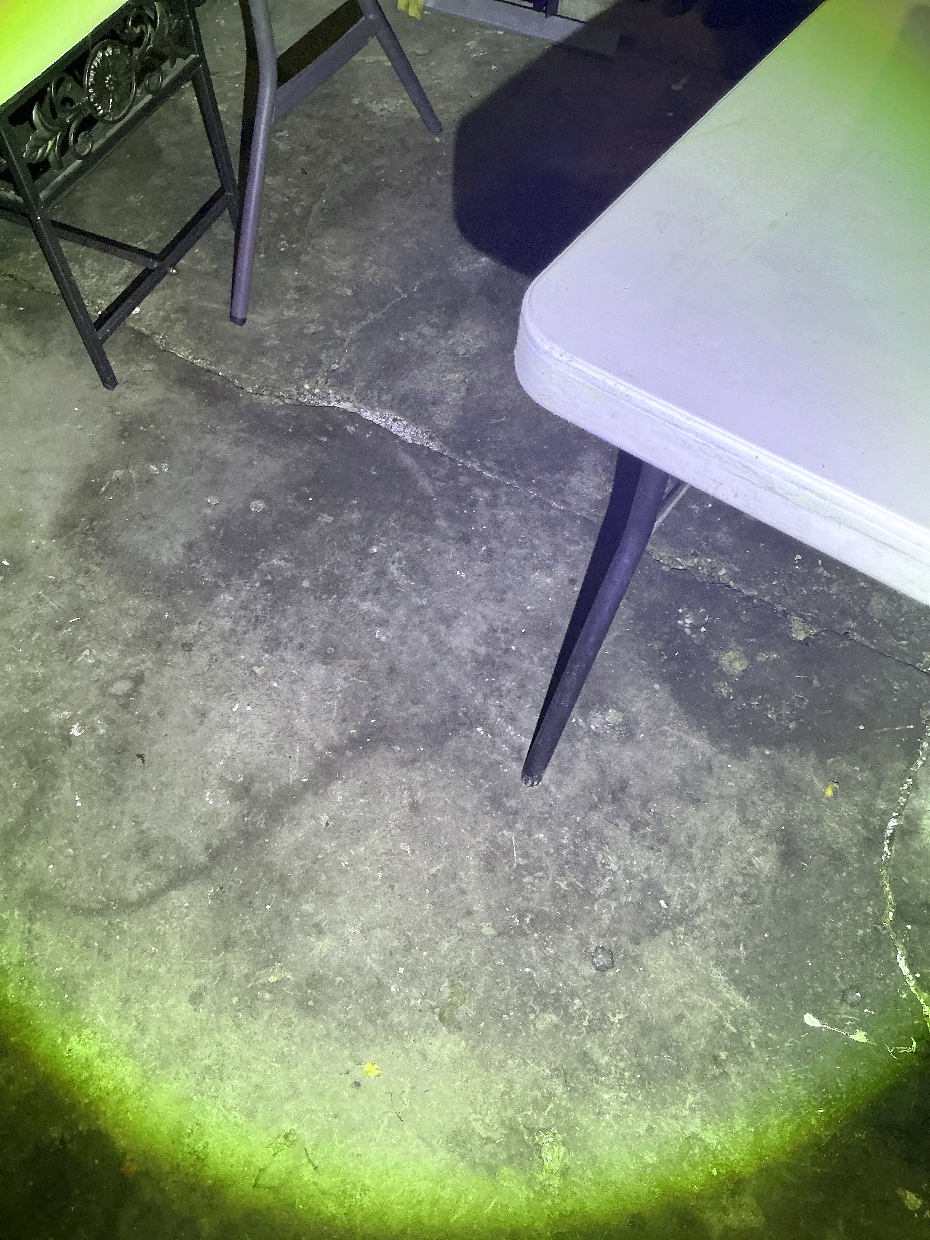 Crack in concrete slab floor illuminated during mold testing 2026-09-03