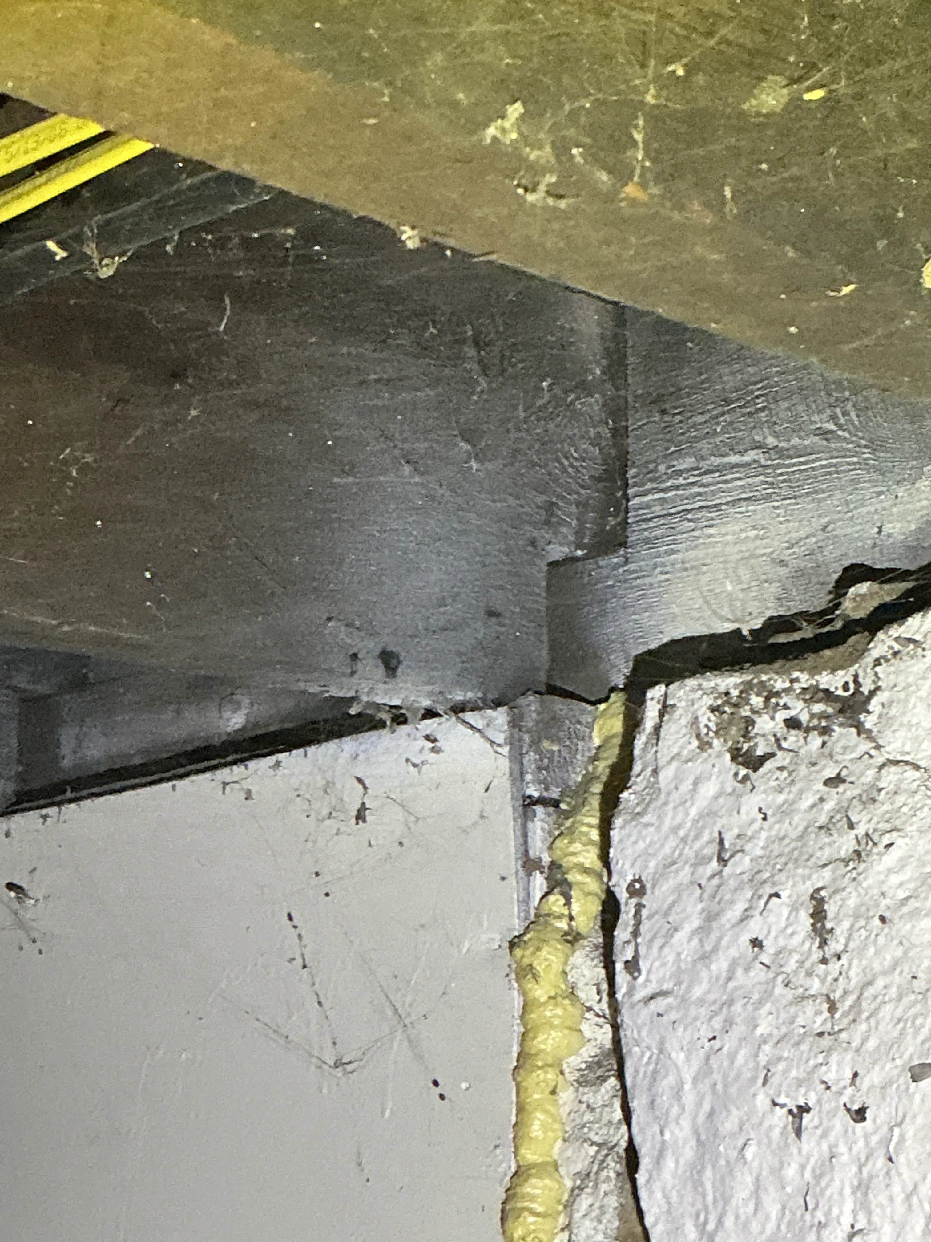 Spray foam sealant applied to gaps in foundation concrete during lead test 2026-09-02