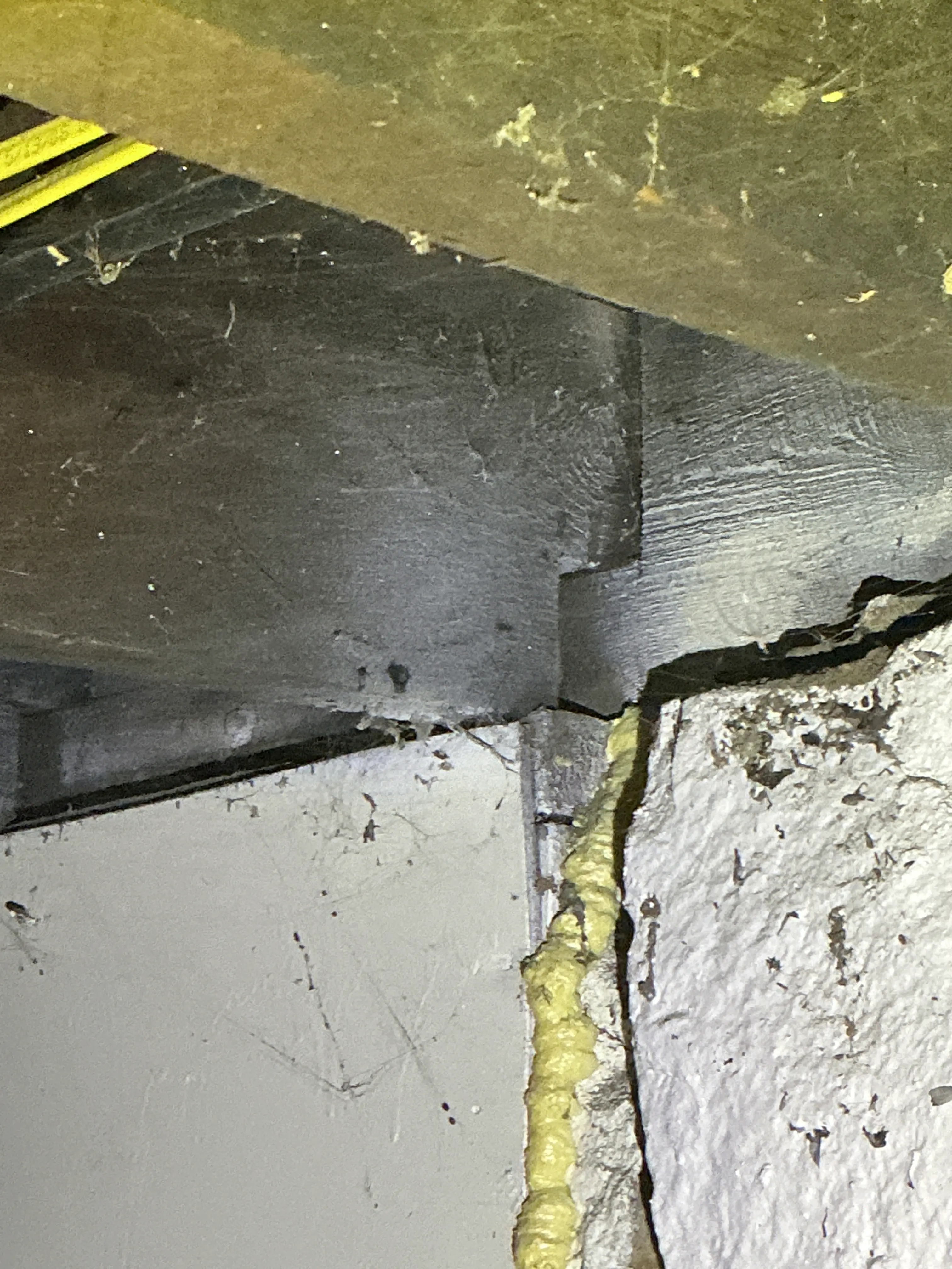 Spray foam sealant applied to gaps in foundation concrete during lead inspection 2026-07-10