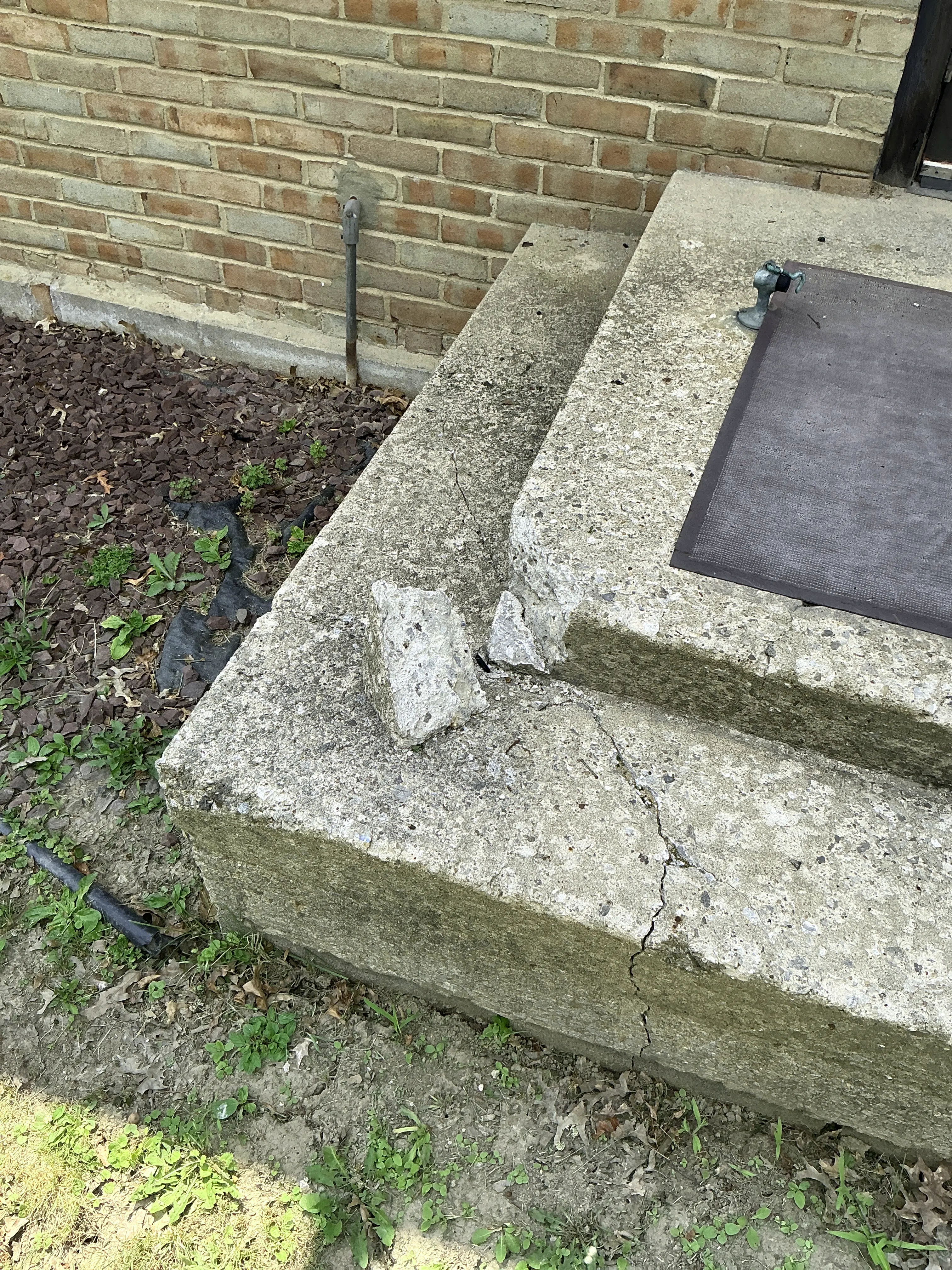 Cracked and broken exterior concrete steps needing masonry repair 2026-08-19