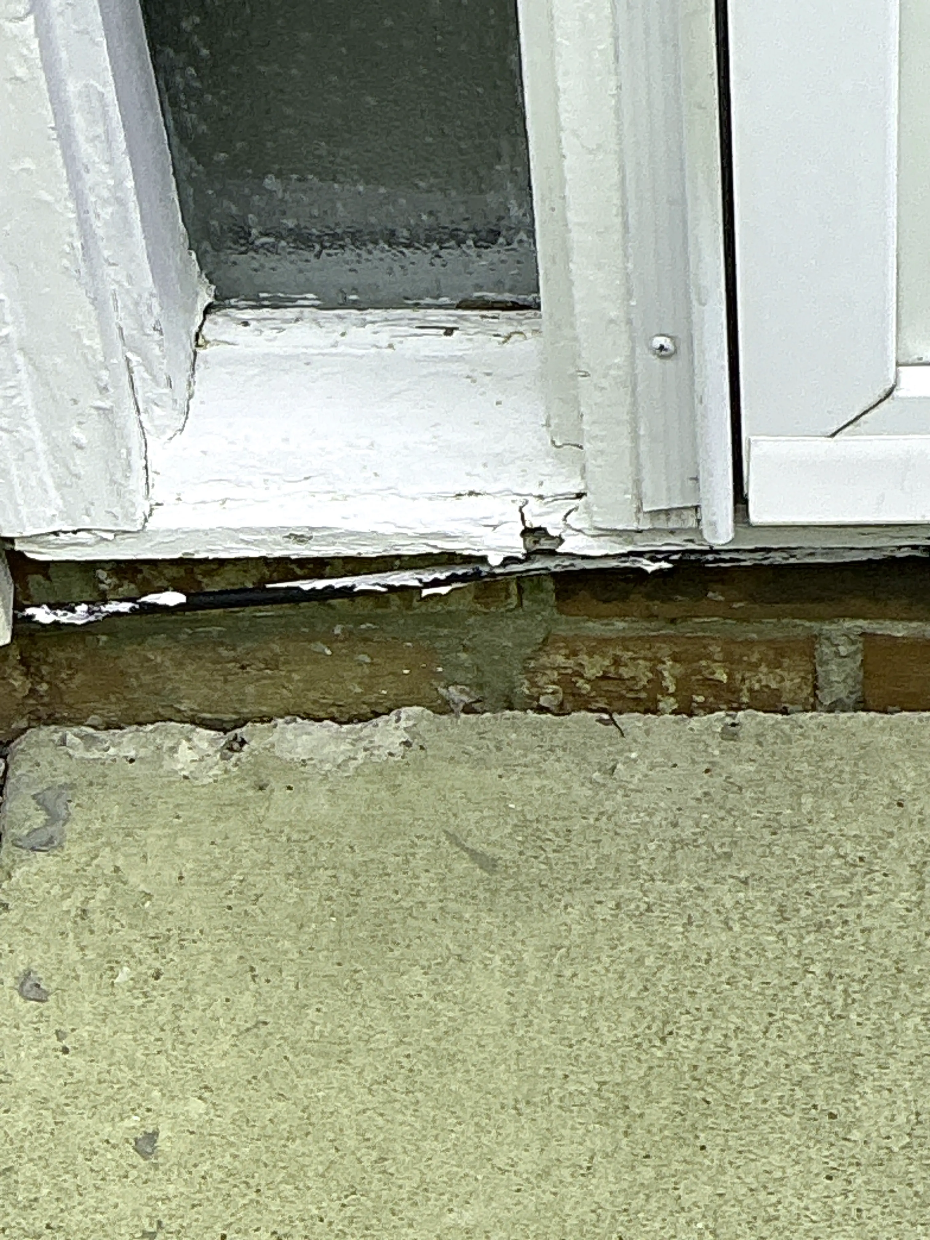 Unsealed gap between window frame and brick exterior wall needing caulking 2026-08-05