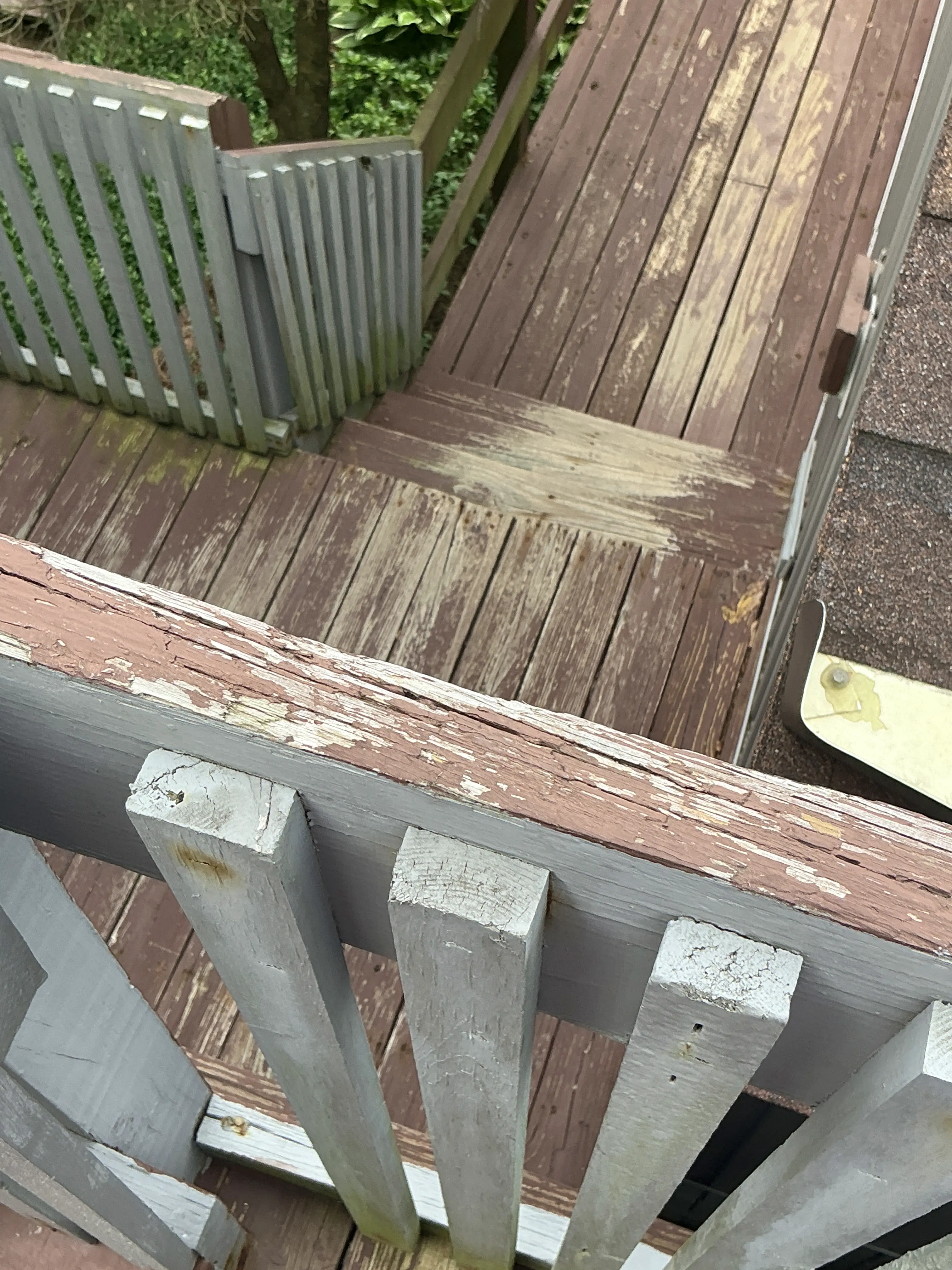 Peeling and deteriorated paint on wooden deck and railing 2026-08-09