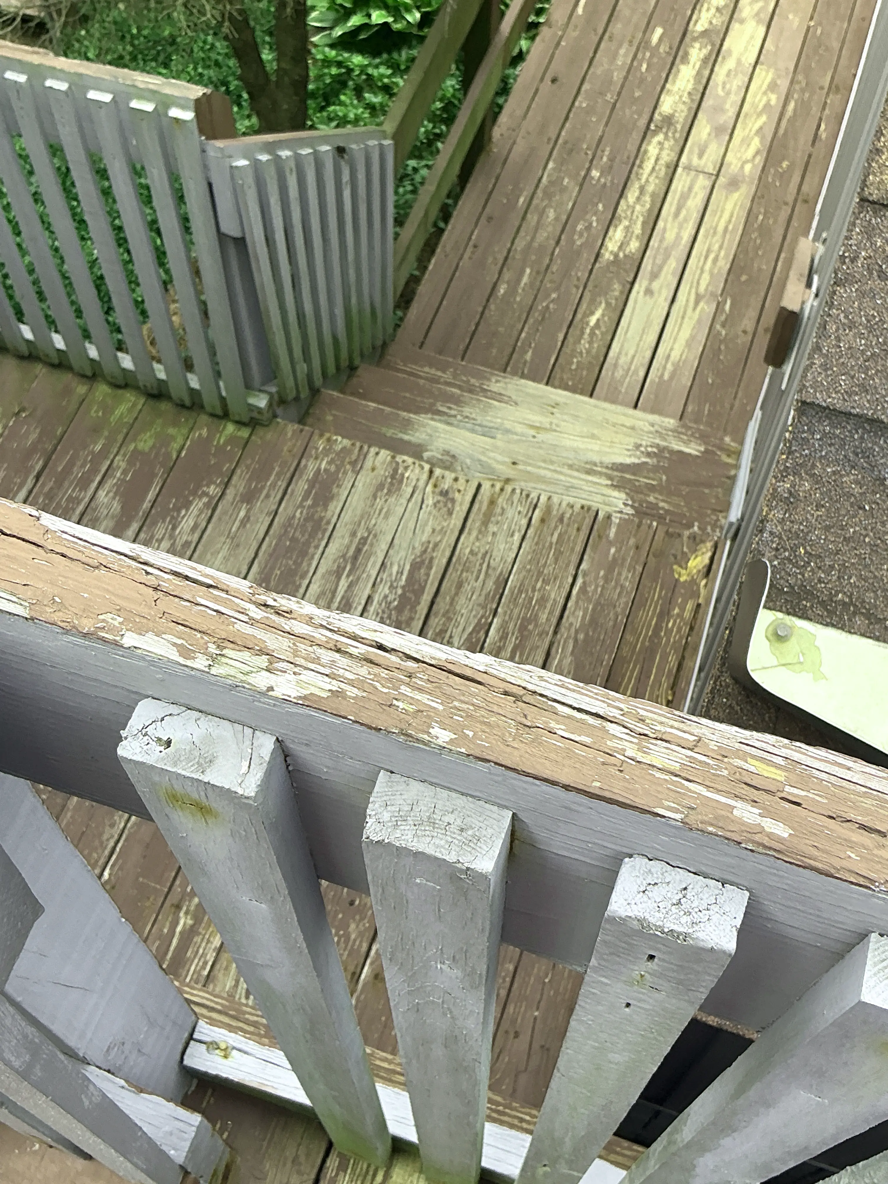 Peeling and deteriorated paint on wooden deck and railing 2026-07-25
