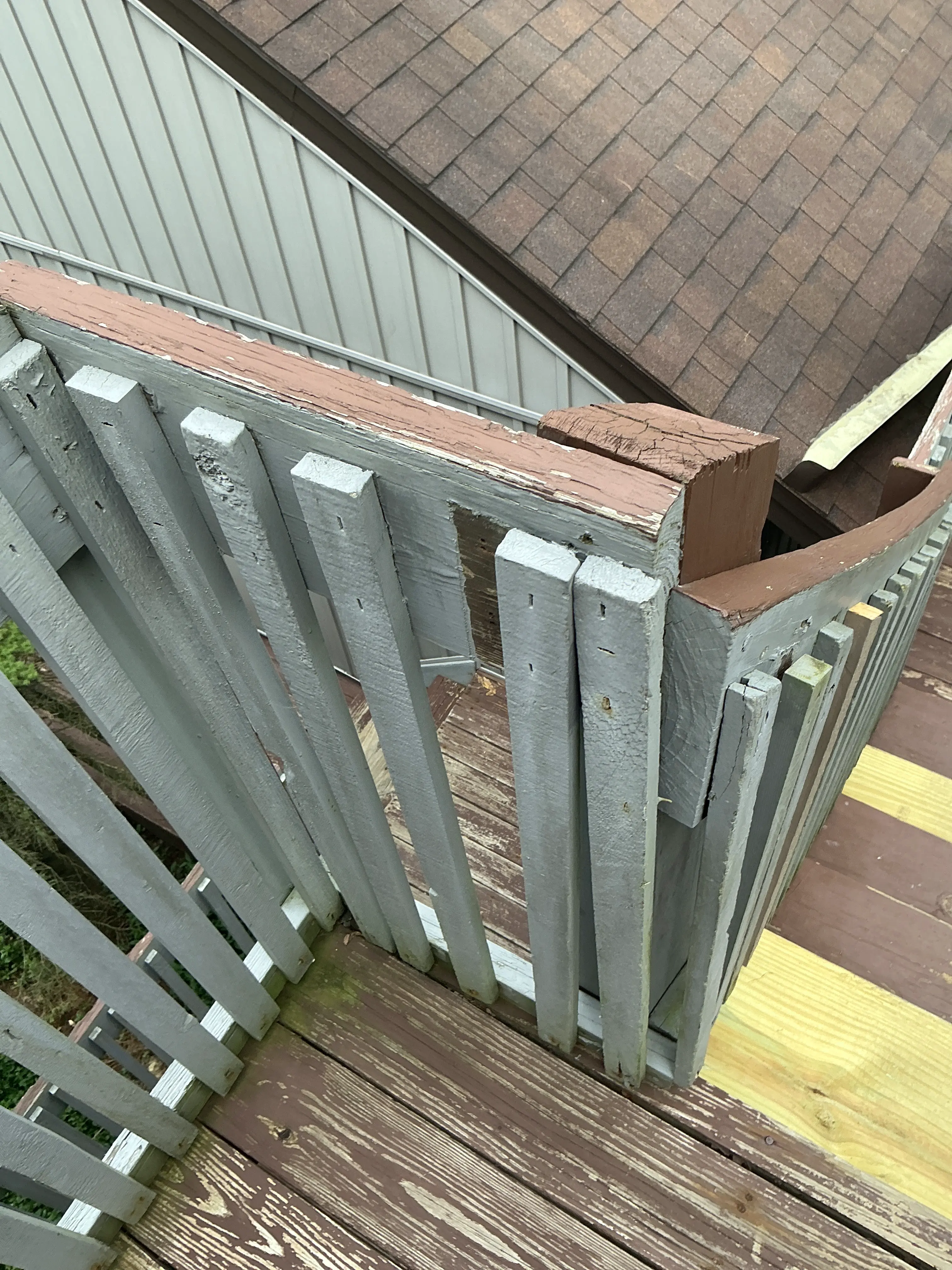 Weathered deck framing with splitting wooden post connection 2026-08-31