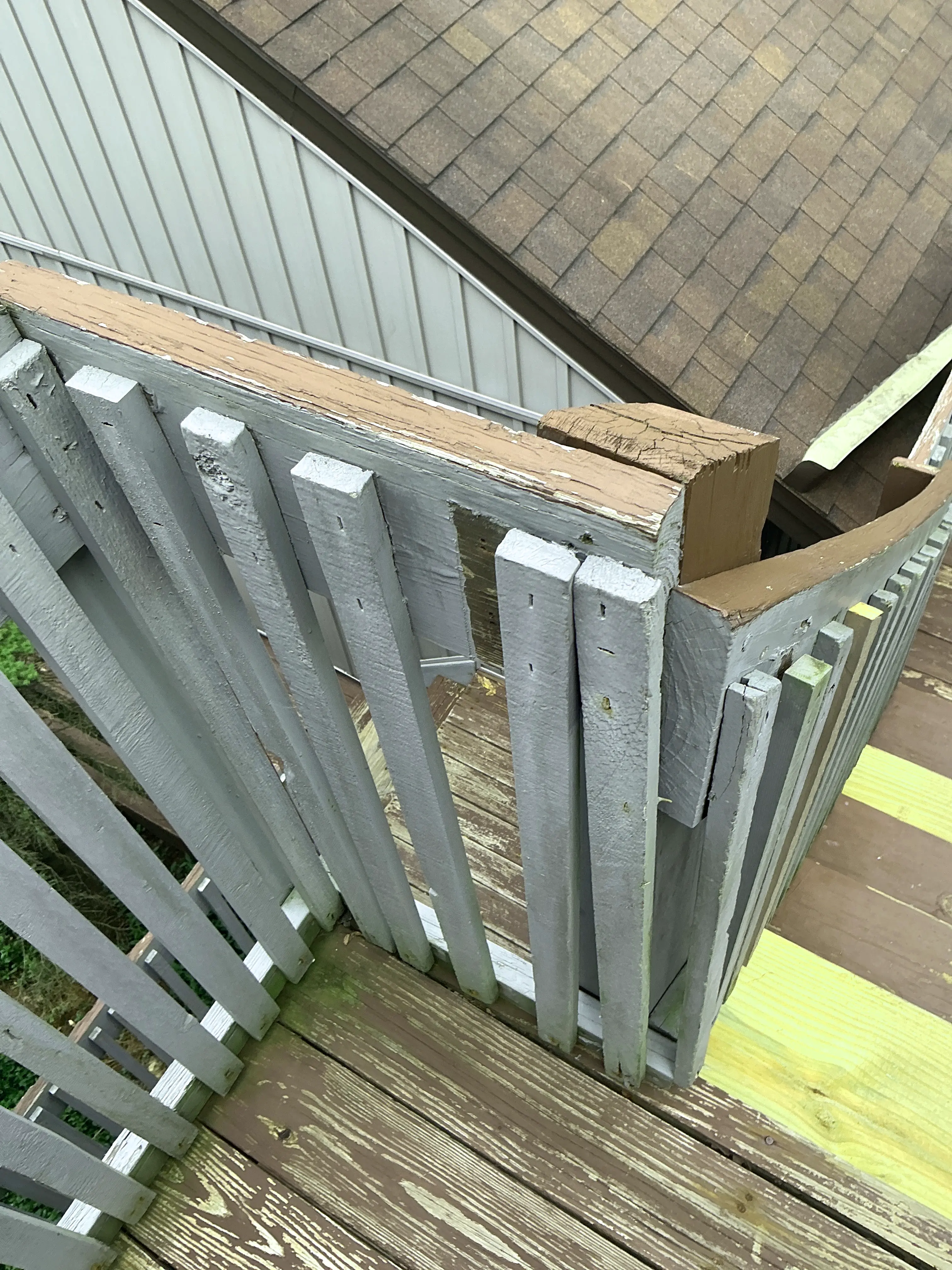 Weathered deck framing with splitting wooden post connection 2026-08-08