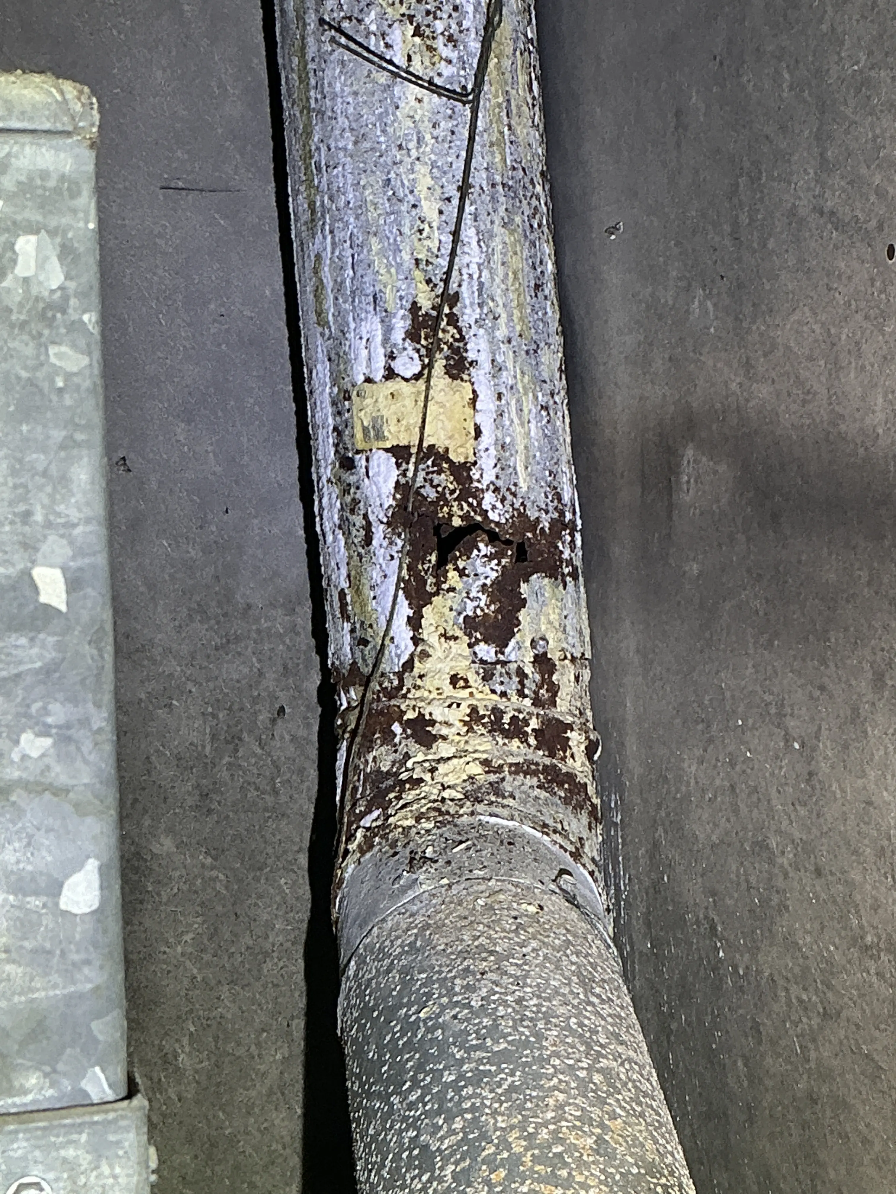 Rusted and damaged metal flue pipe with a hole discovered during a lead inspection 2026-08-25