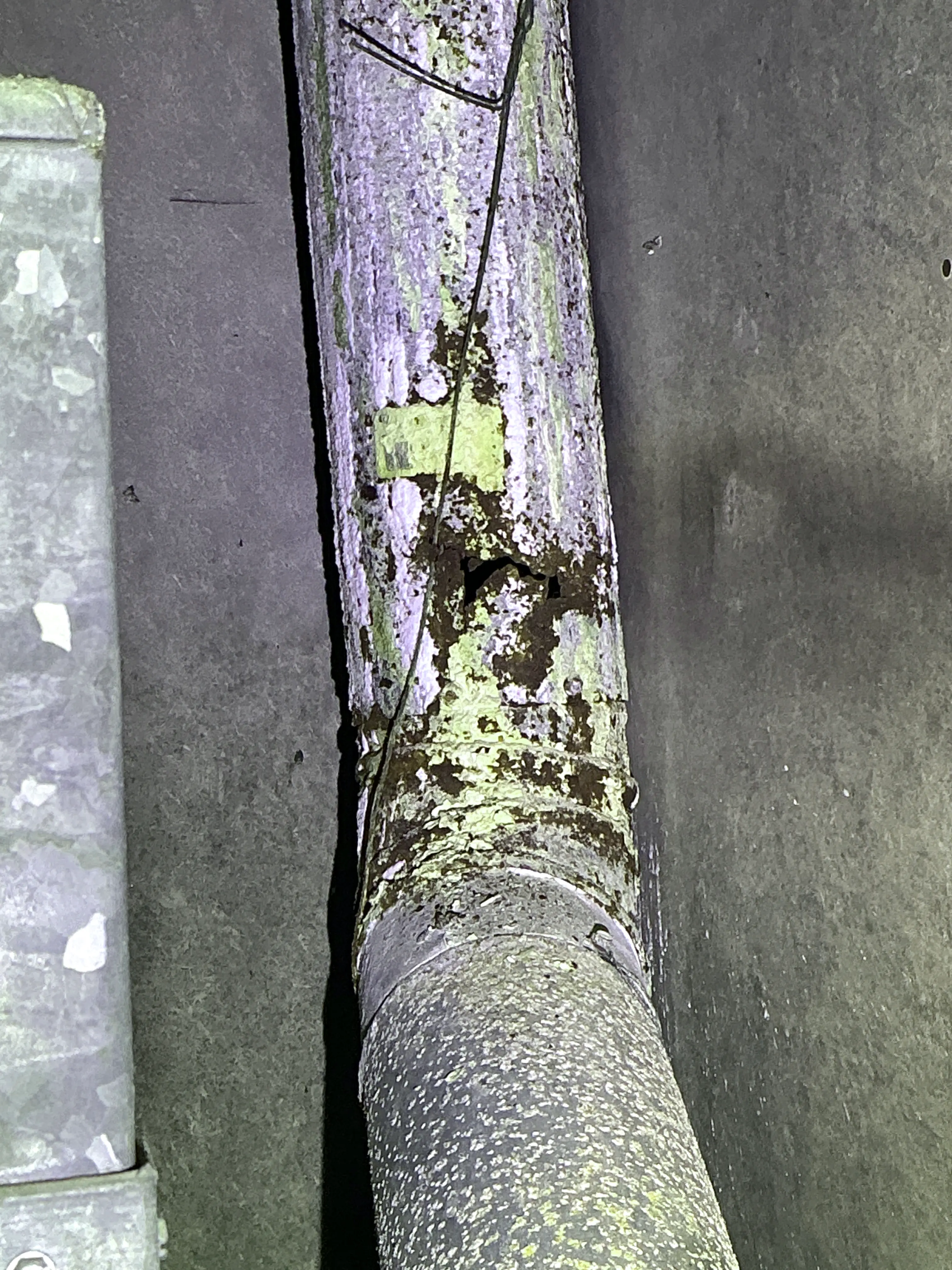 Rusted and damaged metal flue pipe with a hole discovered during a lead test 2026-08-08