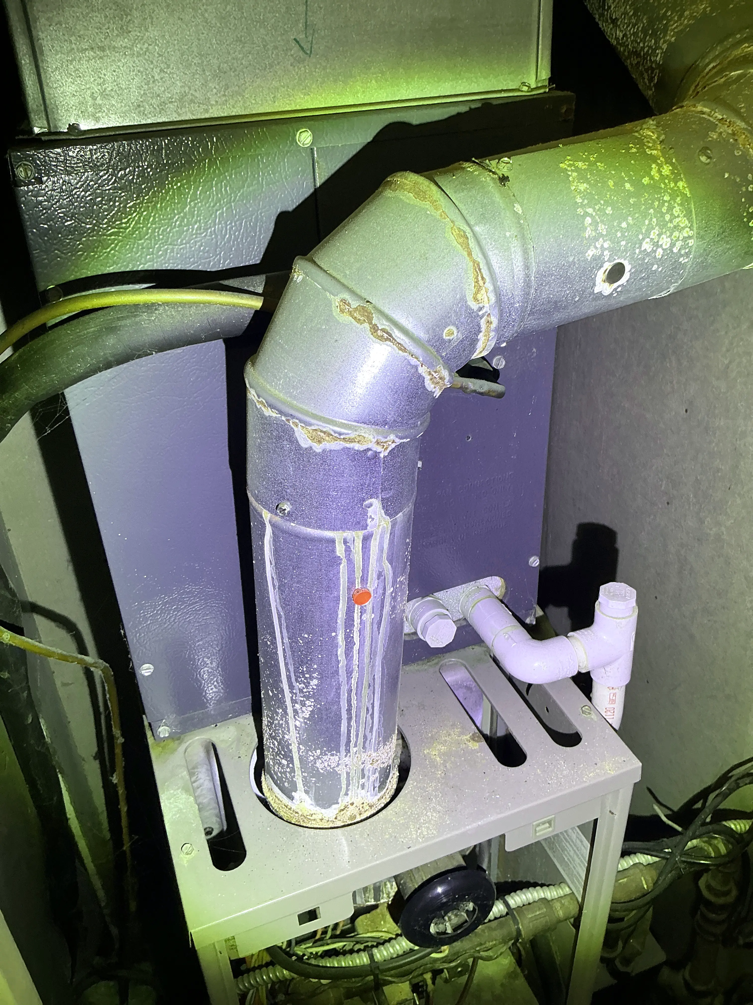 Rust and corrosion visible on a metal furnace flue pipe during a lead test 2026-08-31