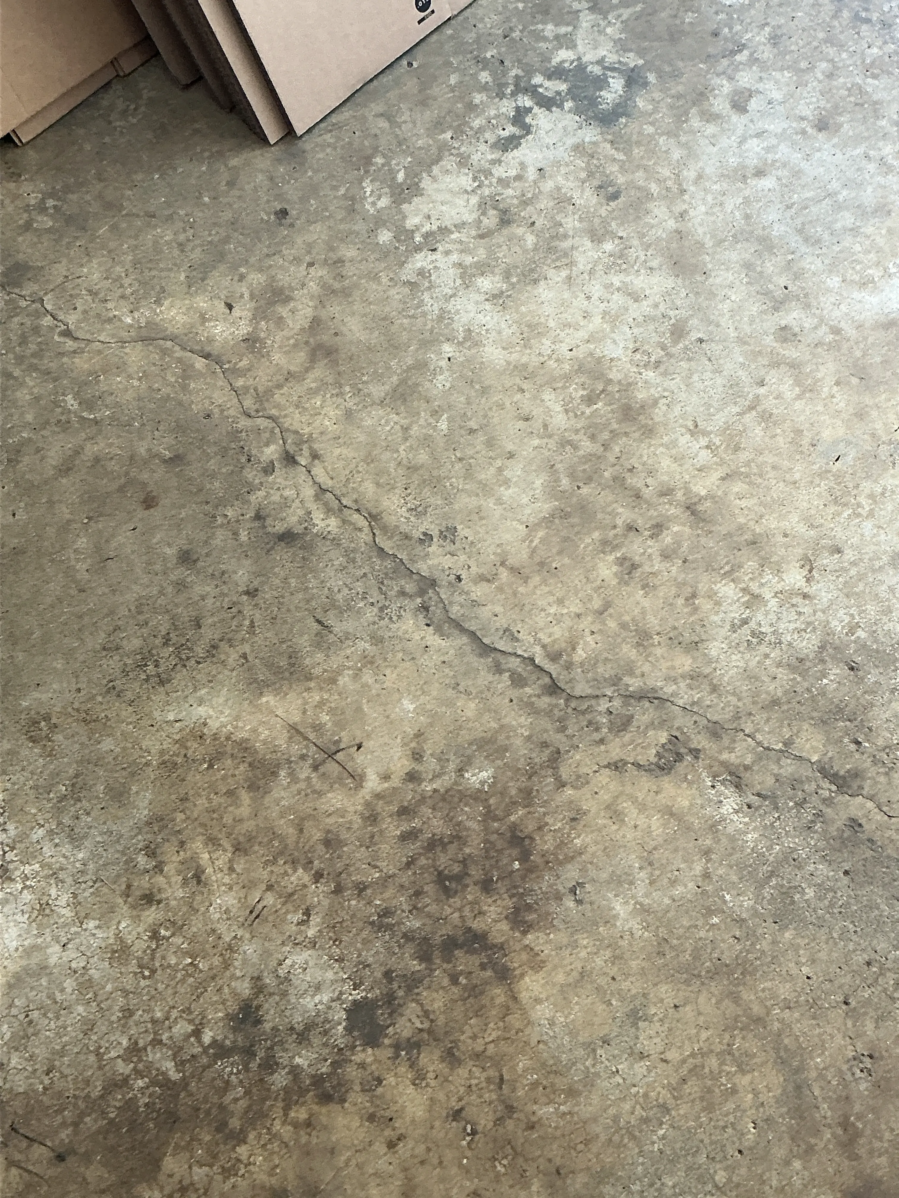 Visible crack in a concrete floor slab during a indoor air quality testing 2026-07-14