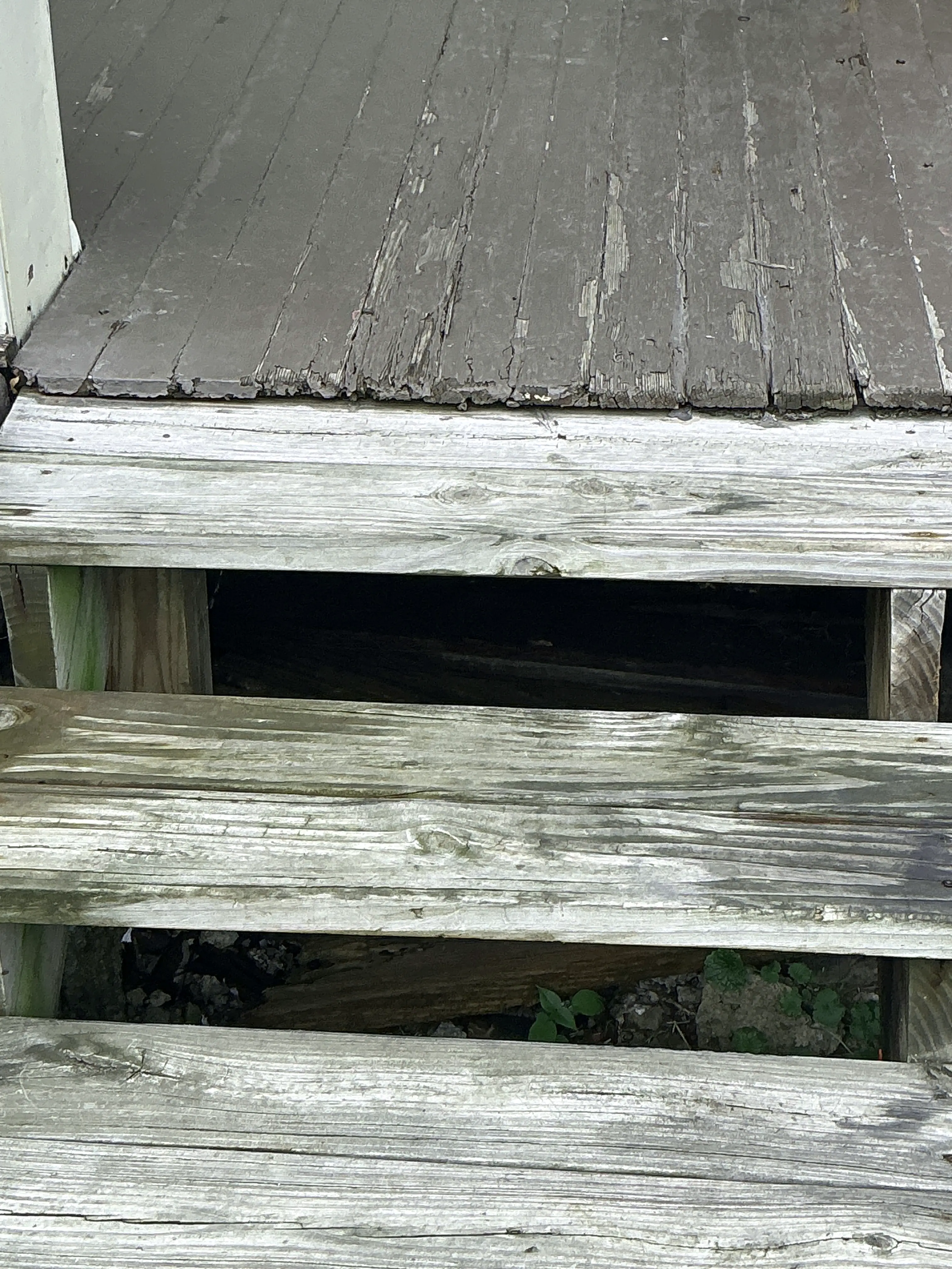 Damaged and weathered exterior wooden siding with large gaps observed during a home inspection 2026-08-27