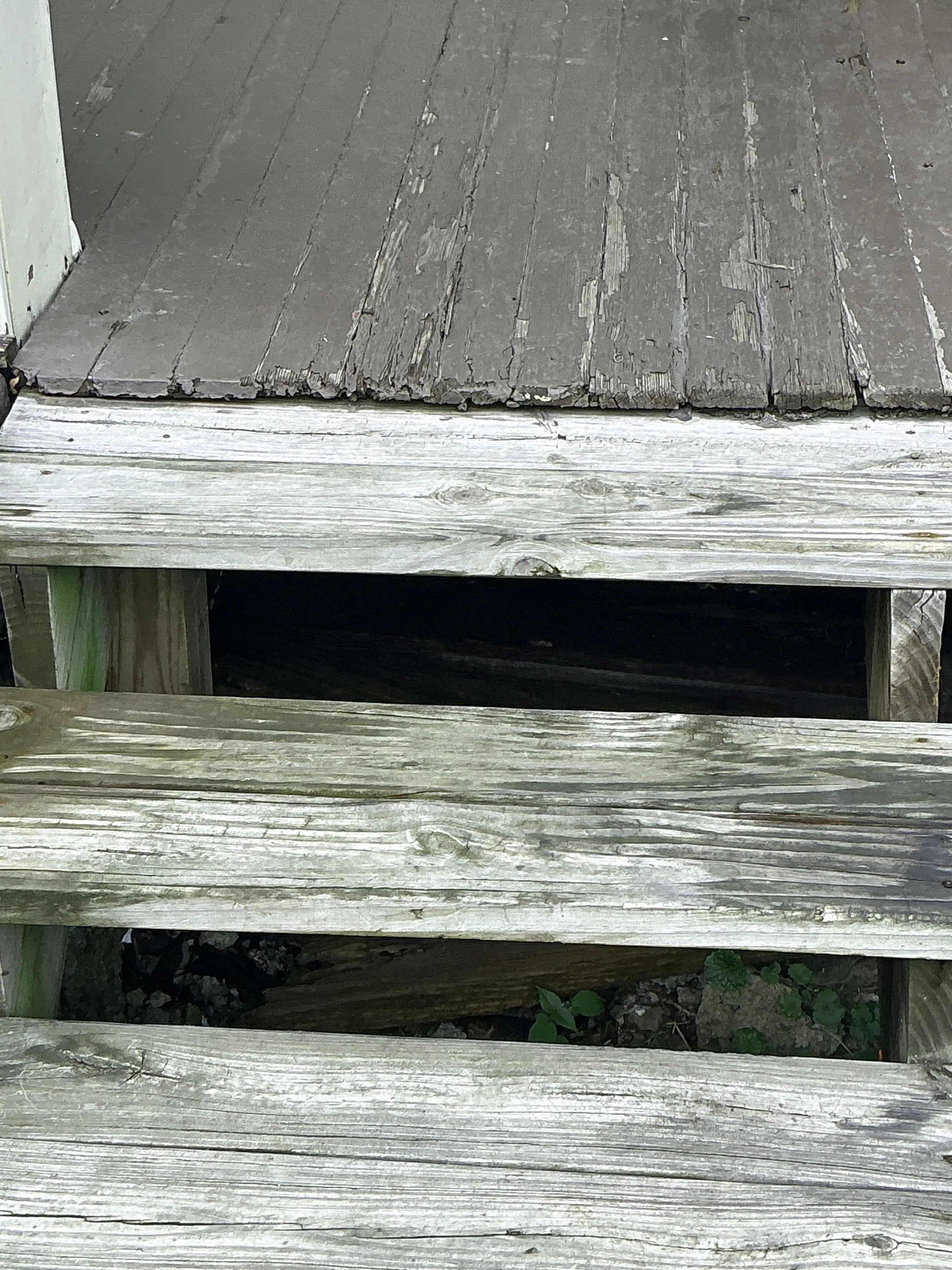 Damaged and weathered exterior wooden siding with large gaps observed during a home inspection 2026-07-29