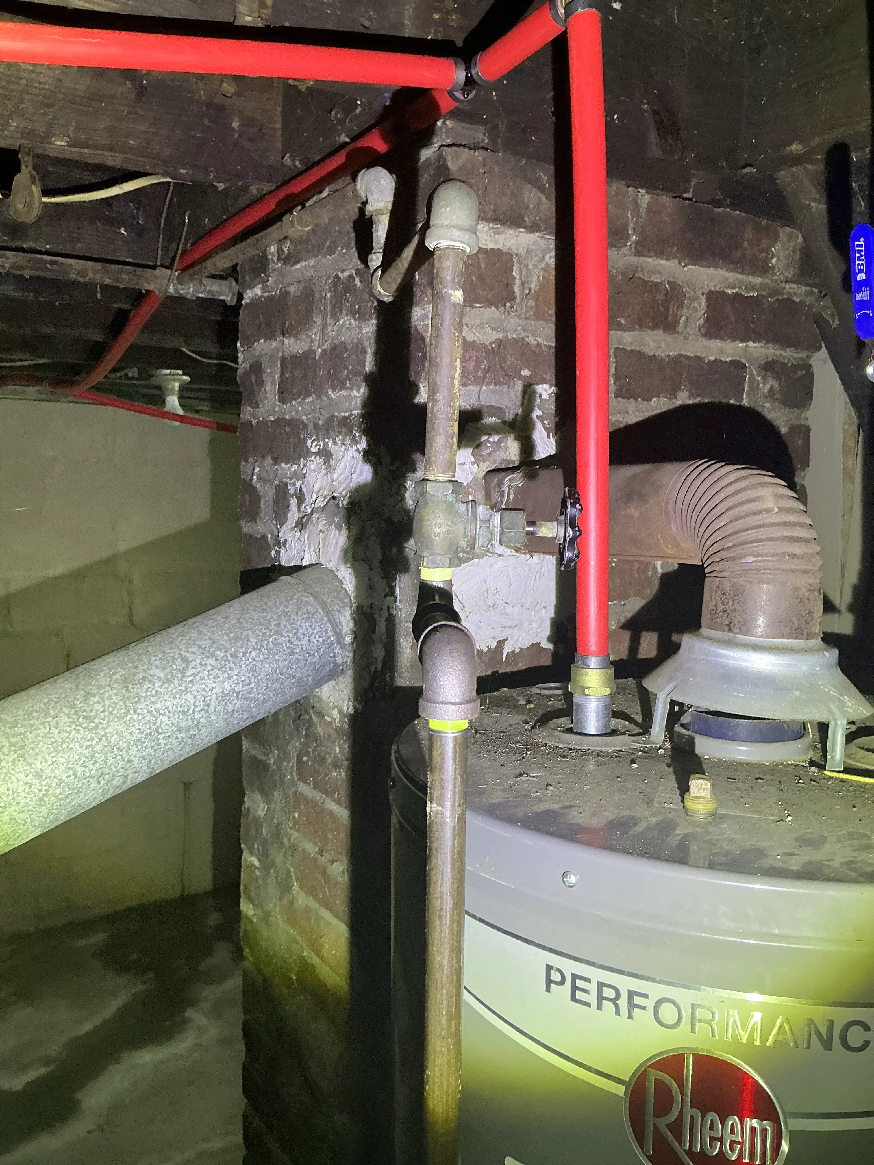 Red PEX piping installed too close to a gas water heater flue vent pipe 2026-08-11