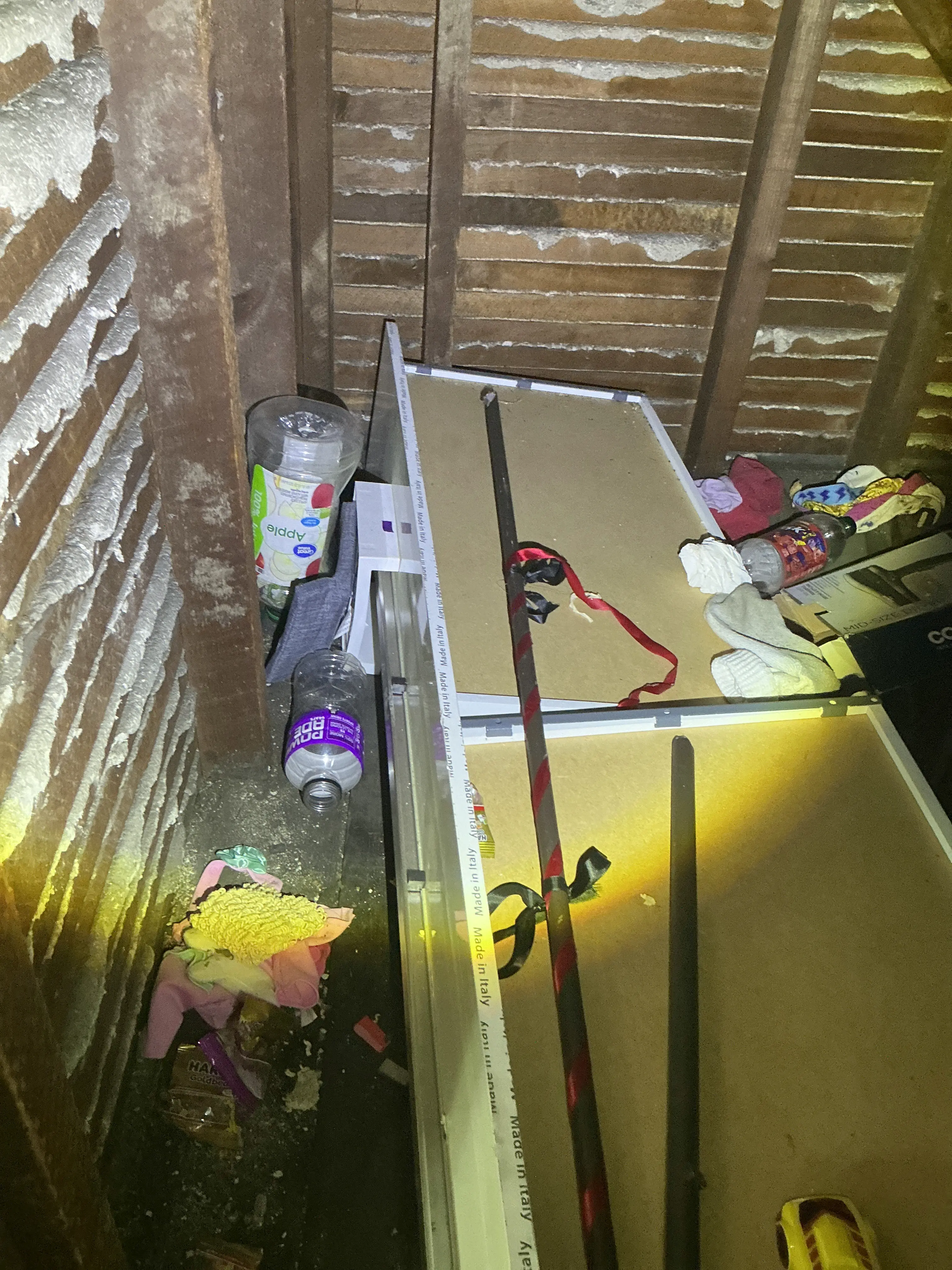 Accumulated clutter and trash debris inside an attic space during home inspection 2026-08-22