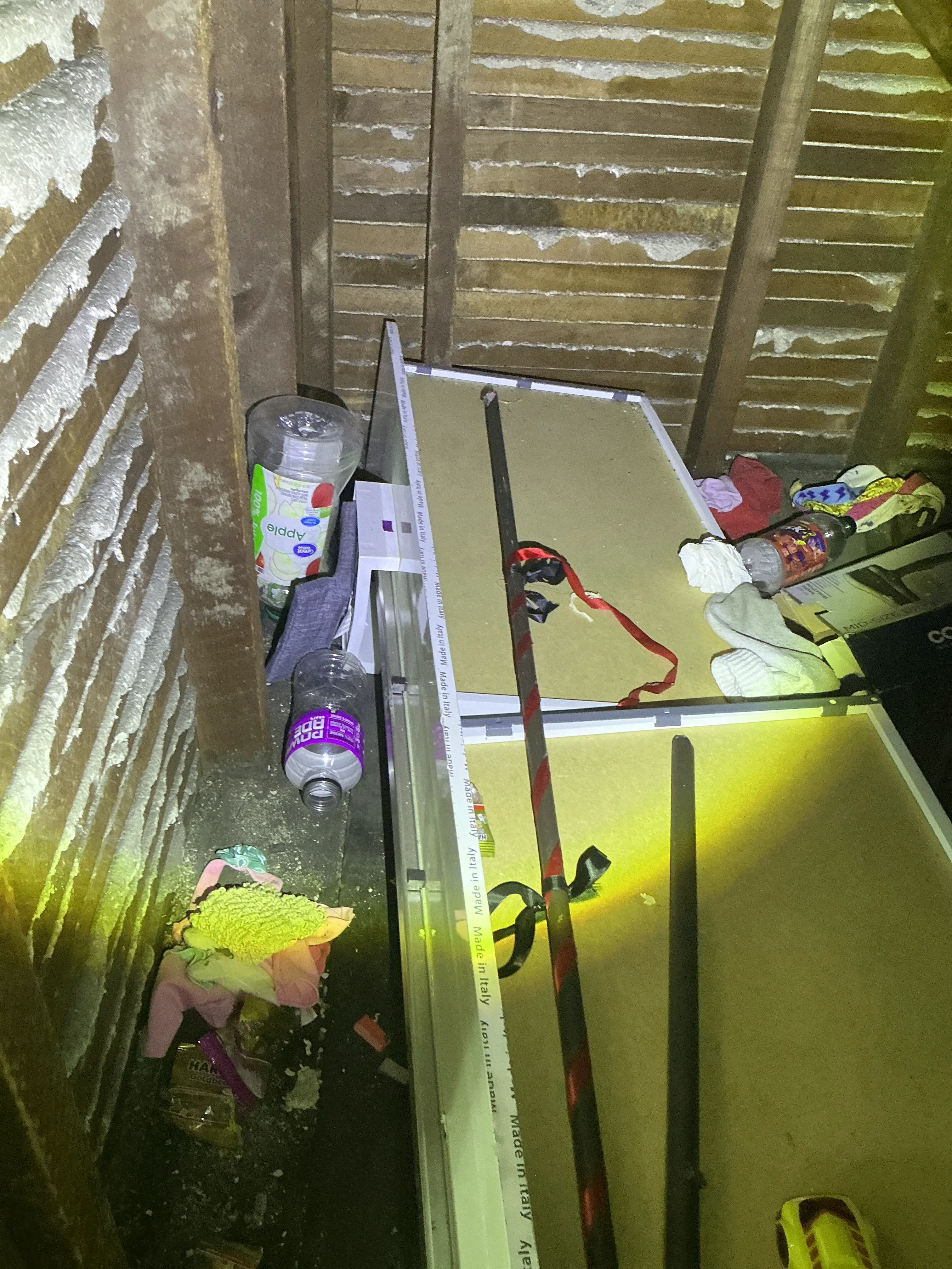 Accumulated clutter and trash debris inside an attic space during mold inspection 2026-08-02