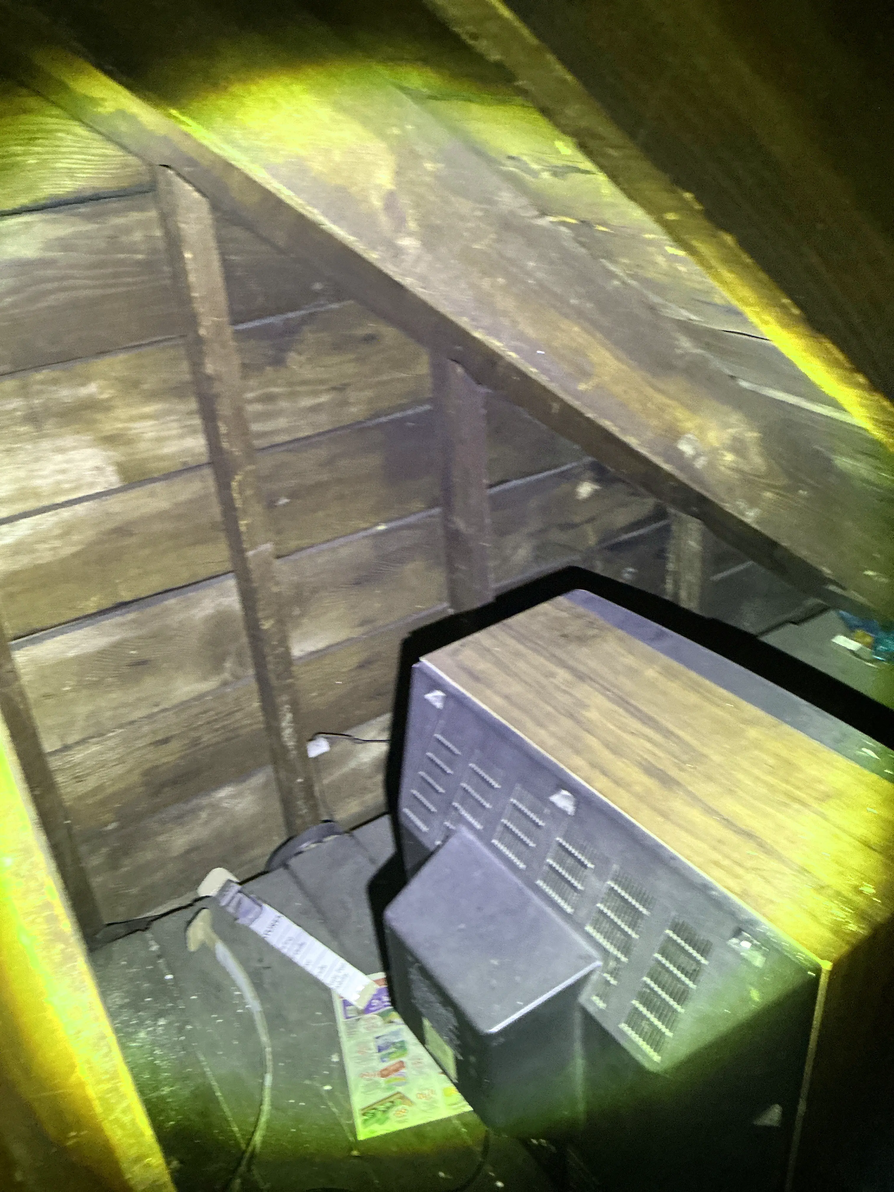 Old television stored inside attic framing during lead test 2026-08-02