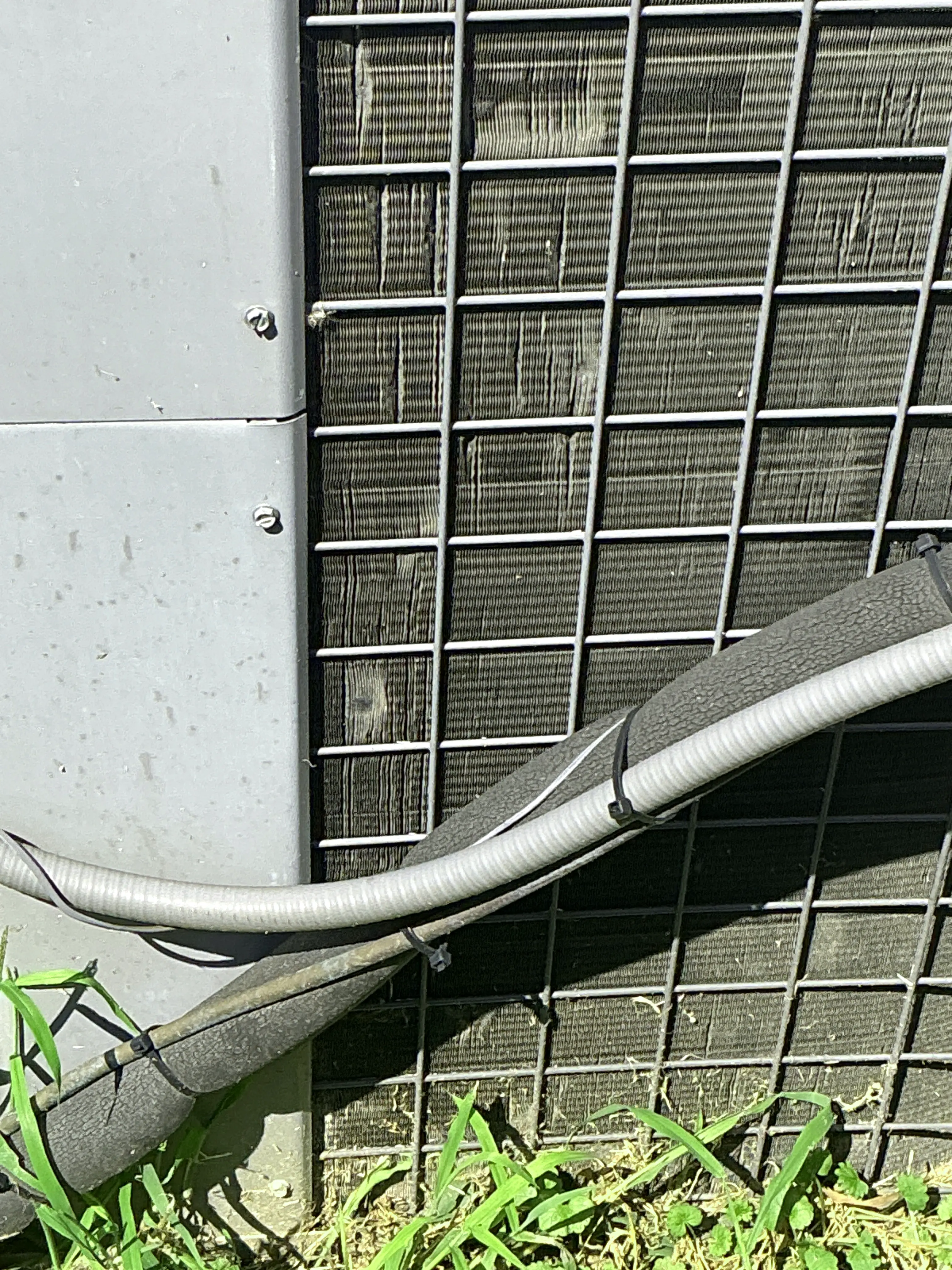 AC unit outdoor refrigerant line insulation with zip ties and damaged cover 2026-07-08
