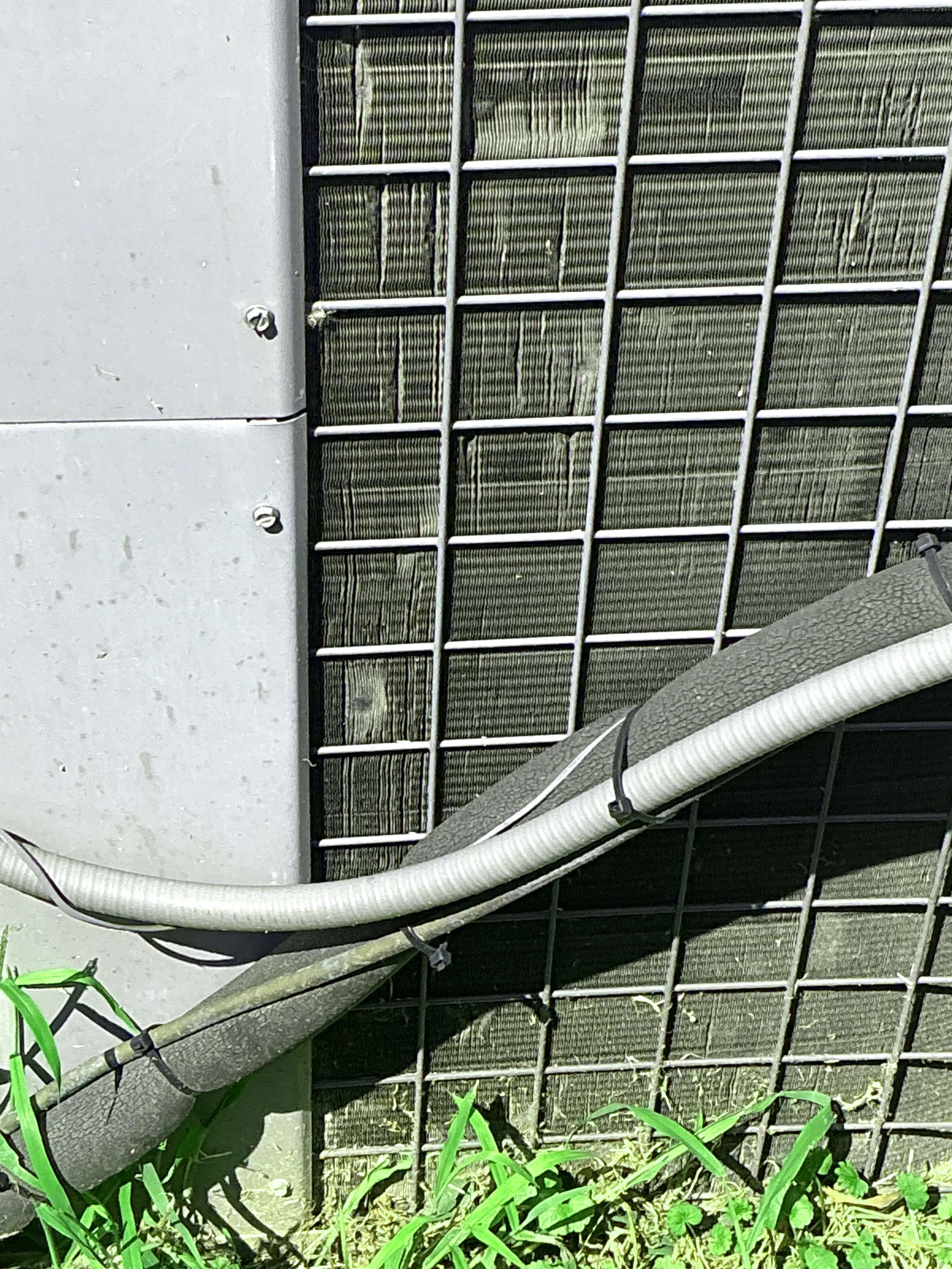 AC unit outdoor refrigerant line insulation with zip ties and damaged cover 2026-08-07