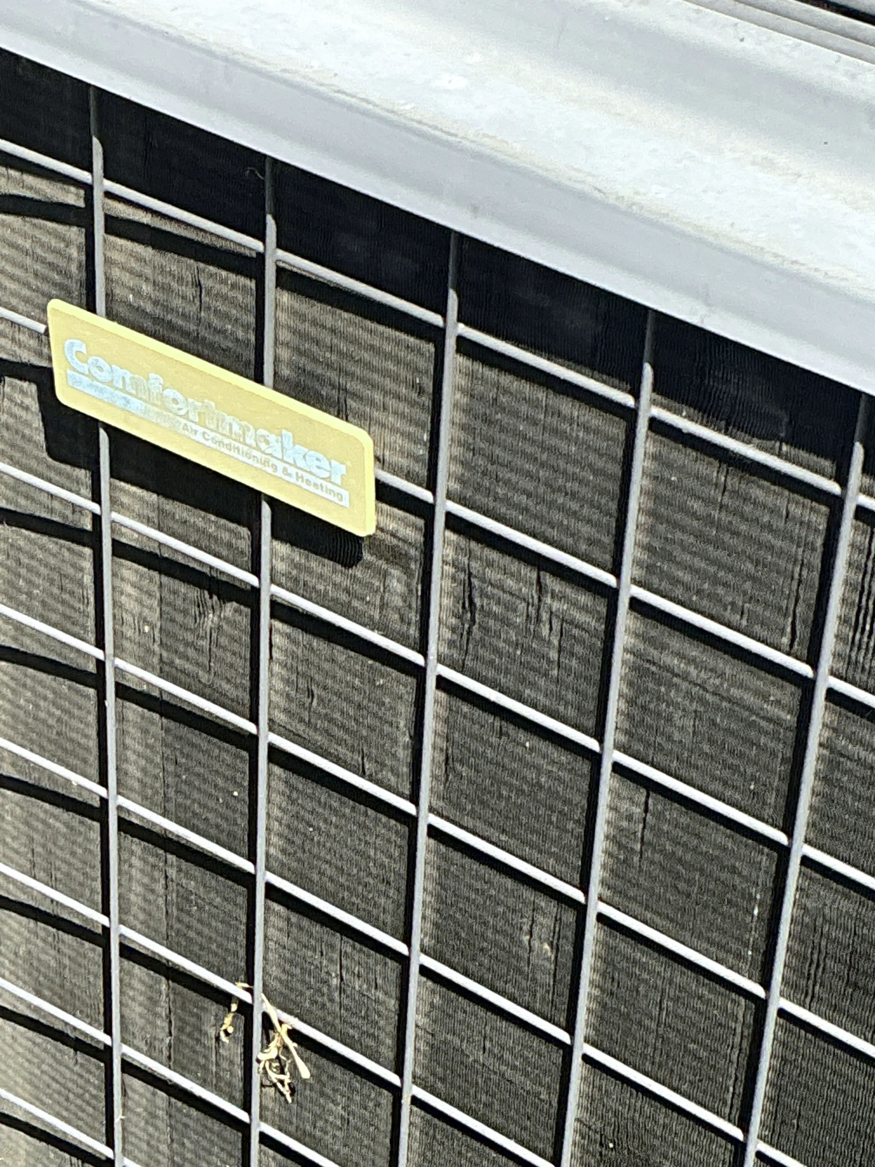 Dirty outdoor air conditioner condenser coil with bent fins 2026-08-04