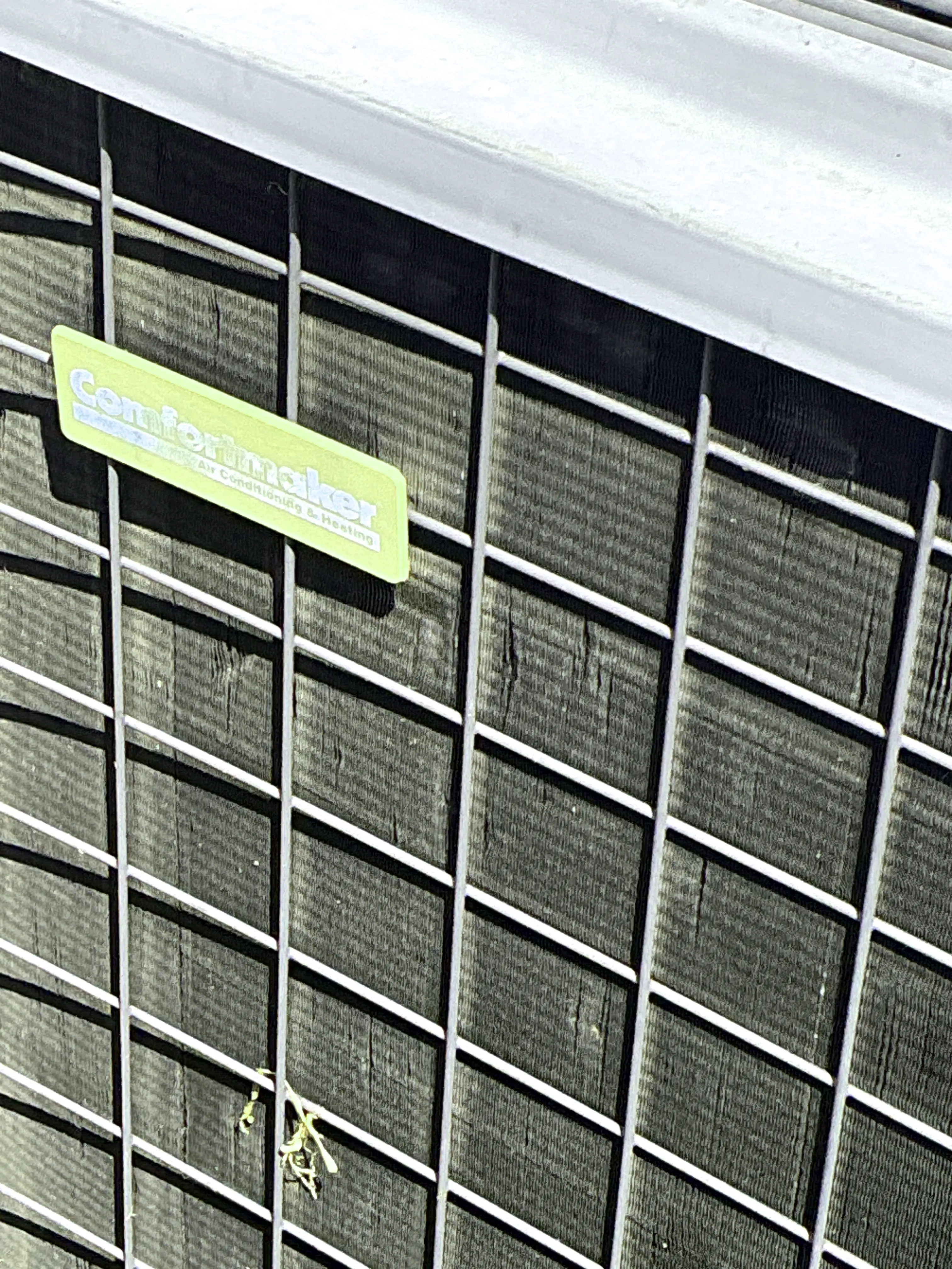 Dirty outdoor air conditioner condenser coil with bent fins 2026-07-30