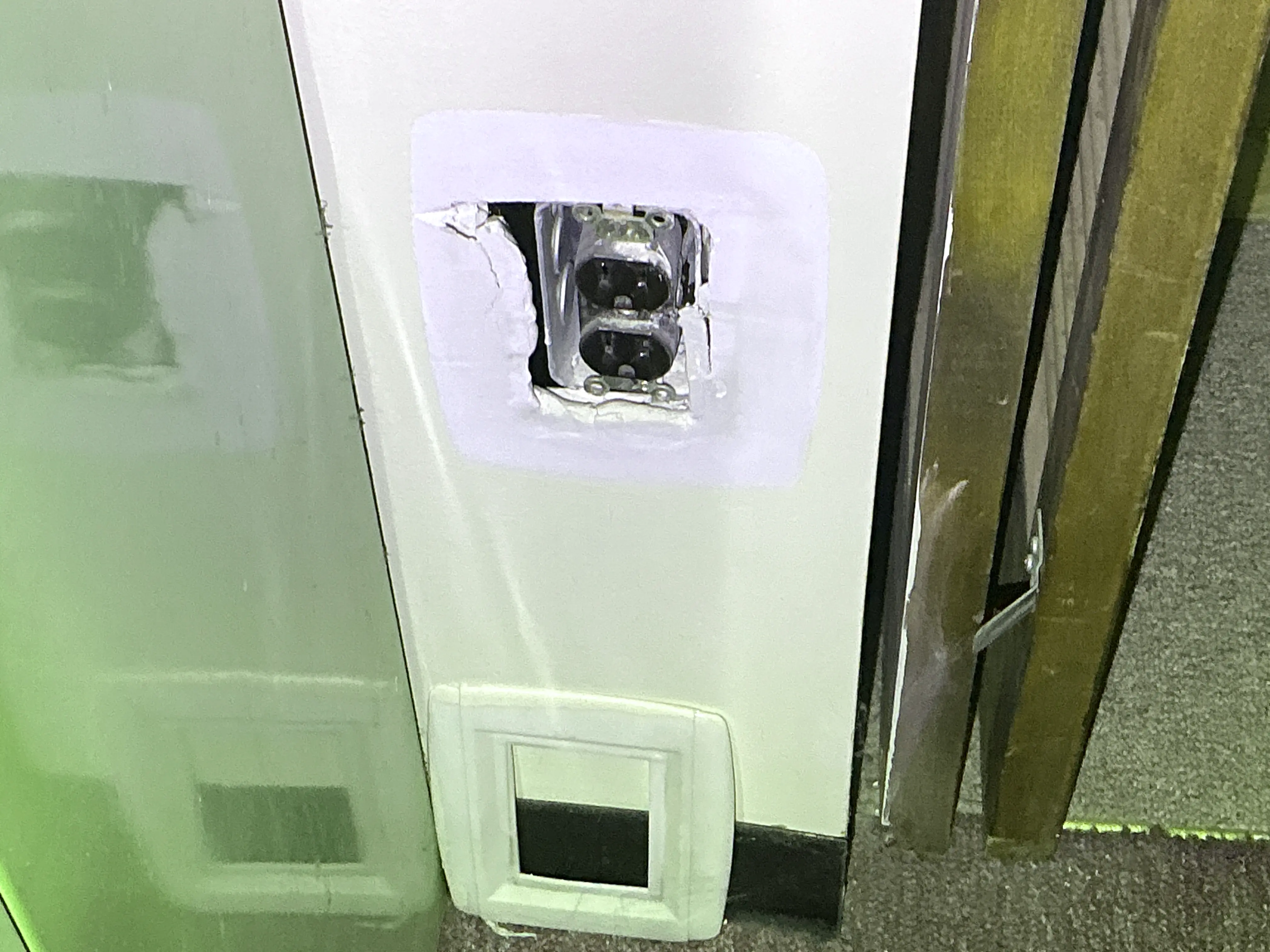 Exposed electrical outlet missing faceplate with damaged drywall repair 2026-08-06