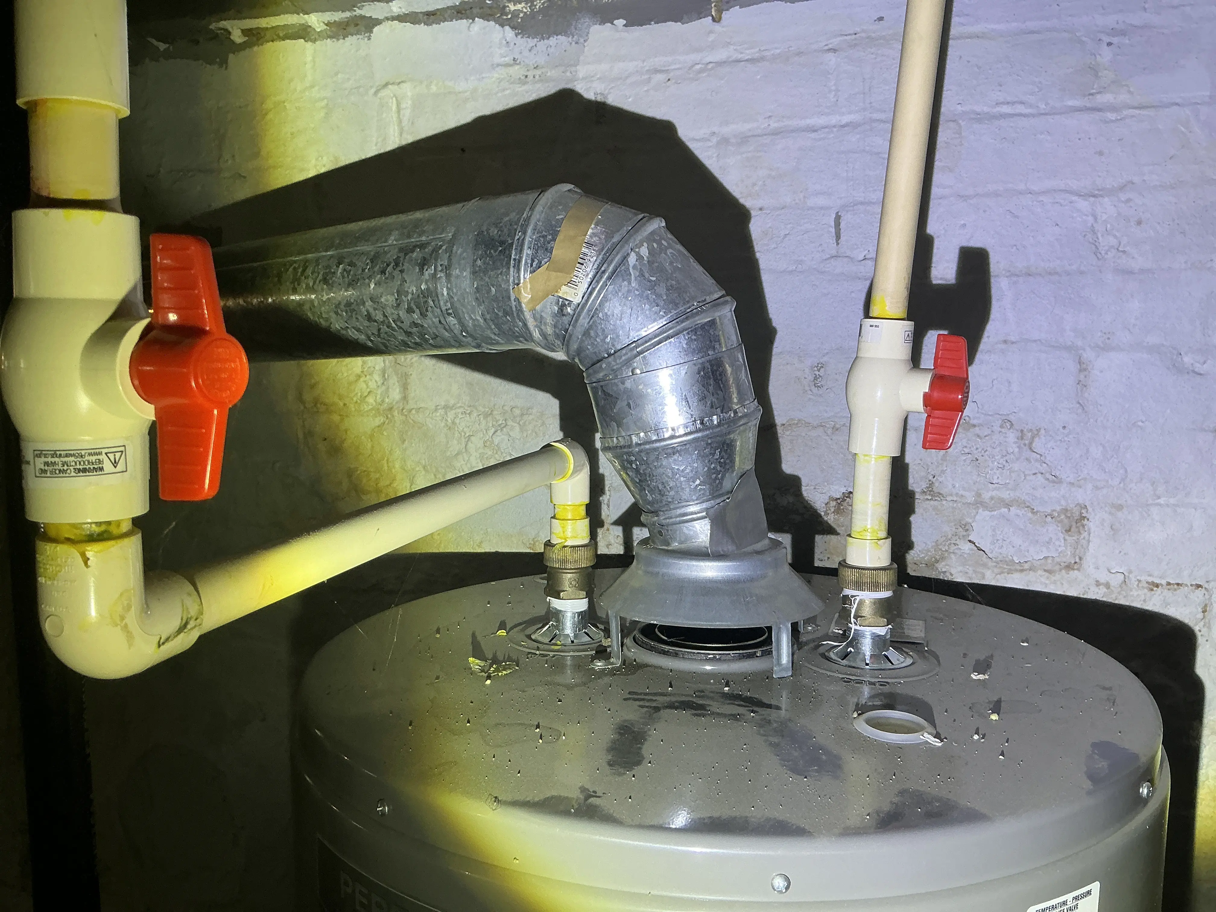 Disconnected vent pipe and draft hood on top of a gas water heater 2026-07-22