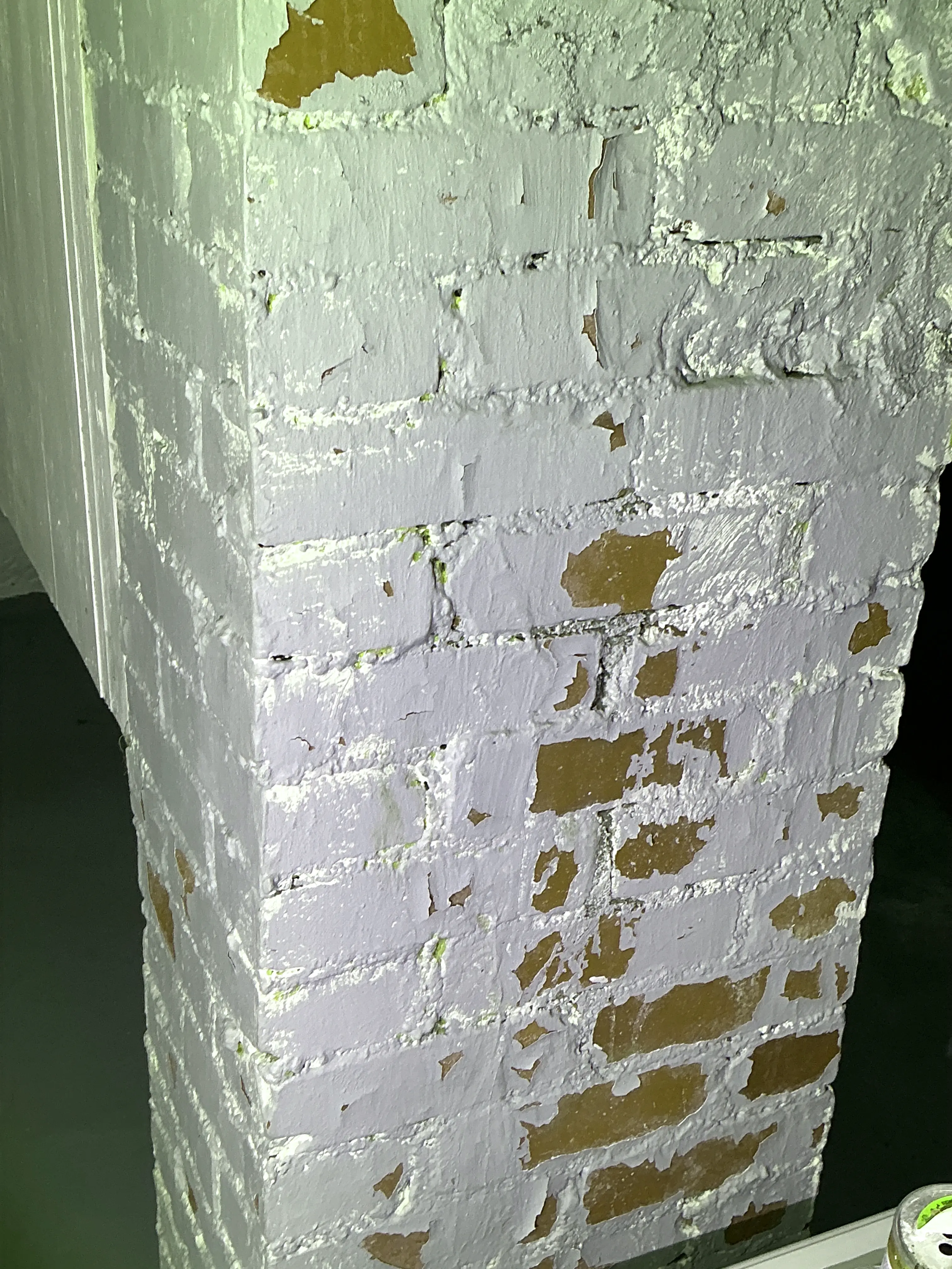 Peeling paint flaking off painted red brick structure during mold testing 2026-09-03