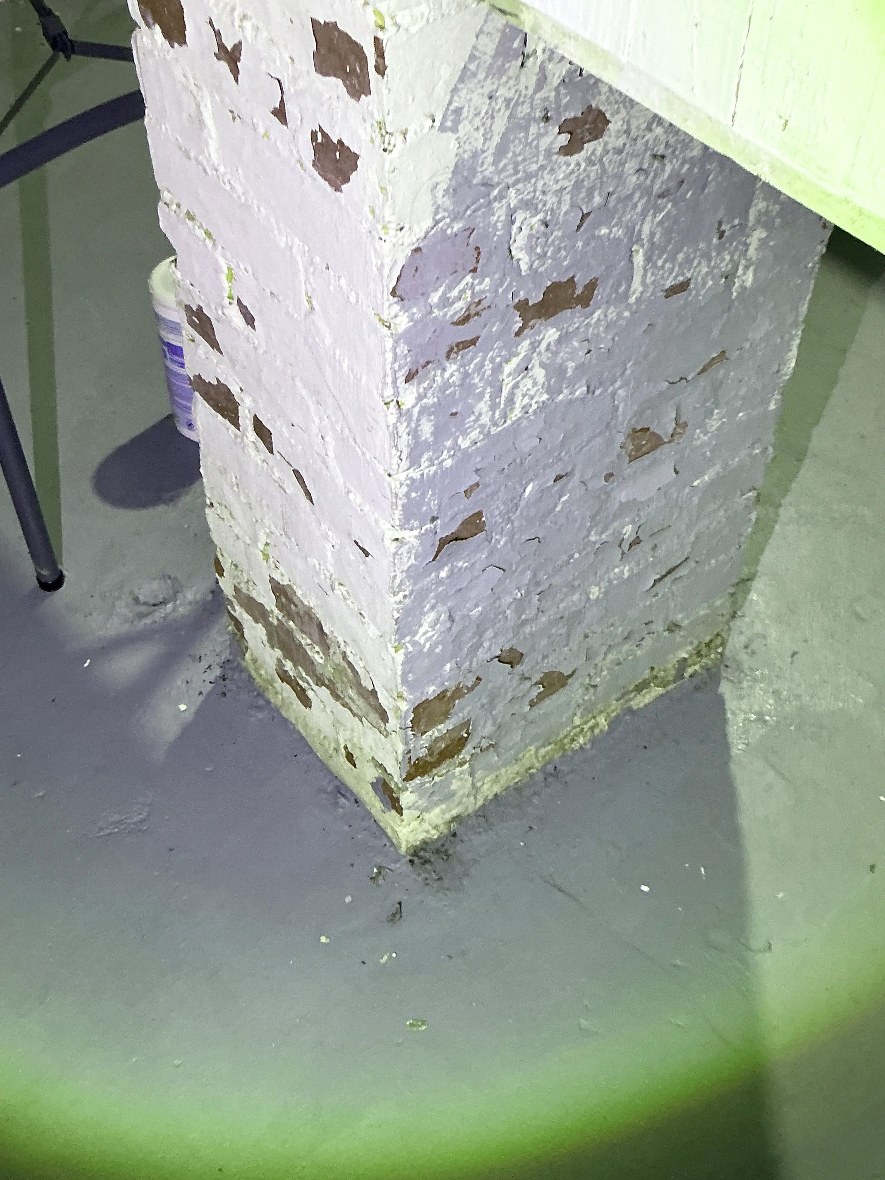 Peeling paint on painted brick pier in basement during lead inspection 2026-07-12