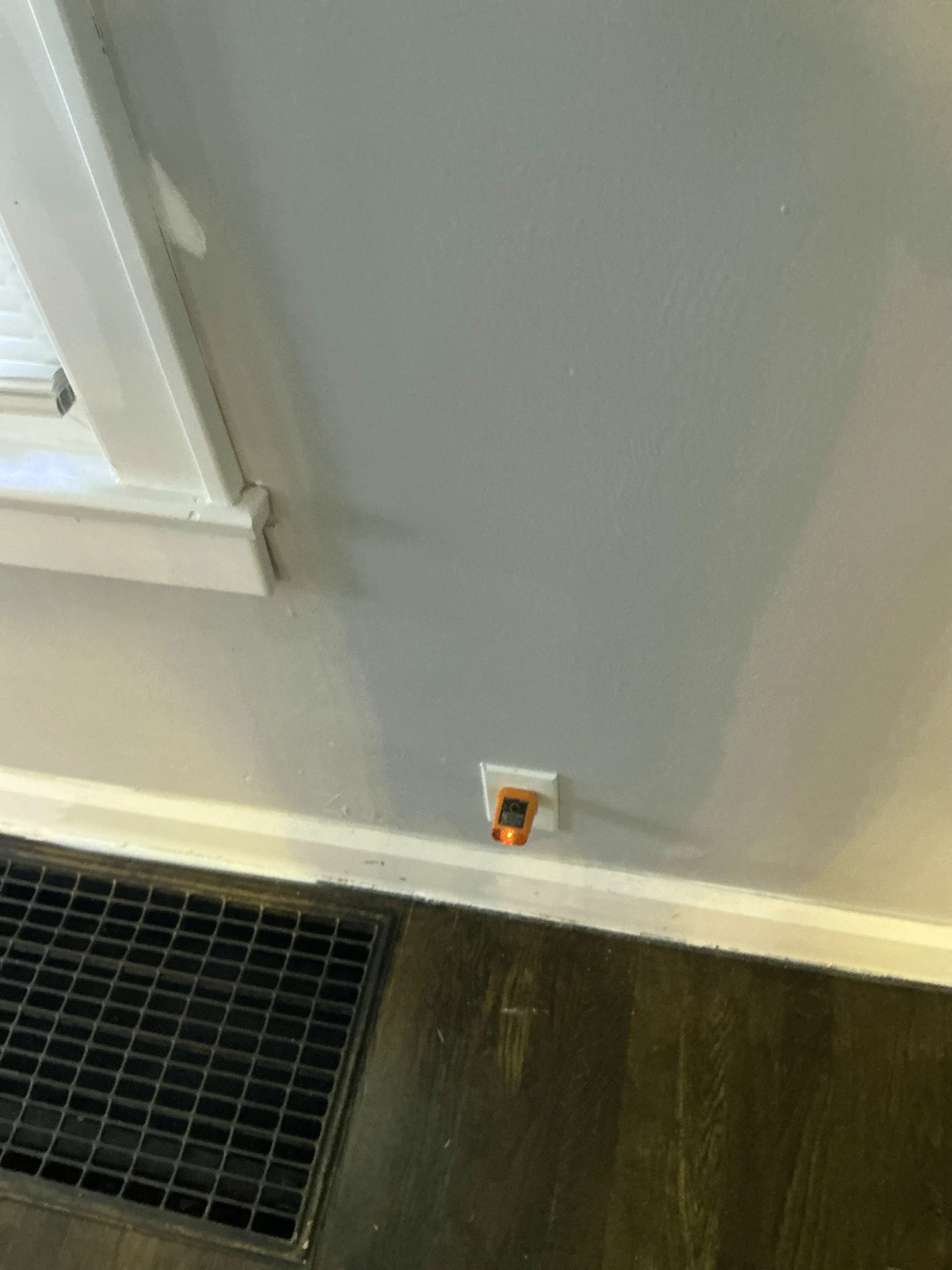 Circuit tester plugged into a wall outlet during a mold inspection 2026-07-08