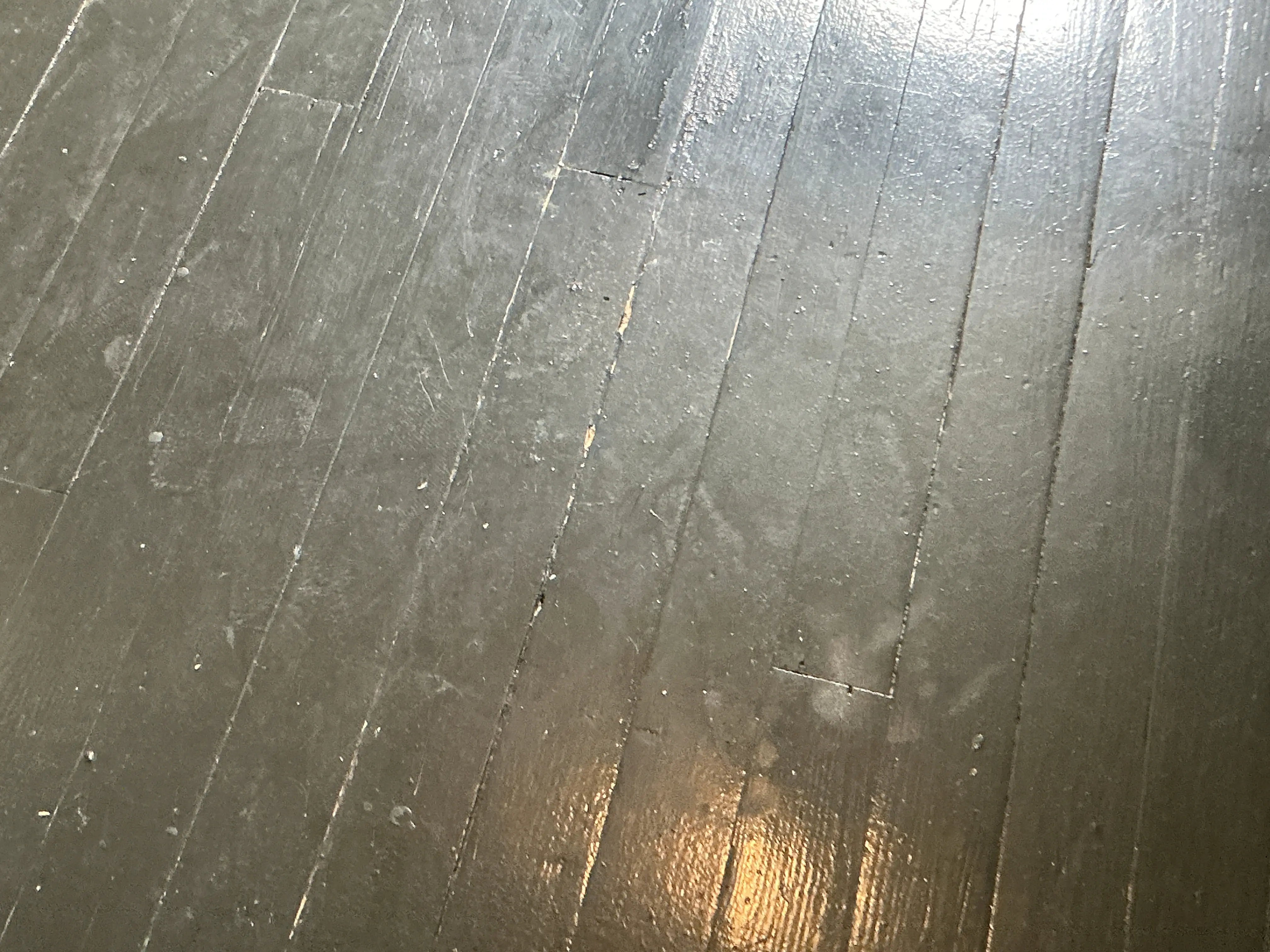 Scratched and worn painted wooden floorboards in need of refinishing 2026-07-31