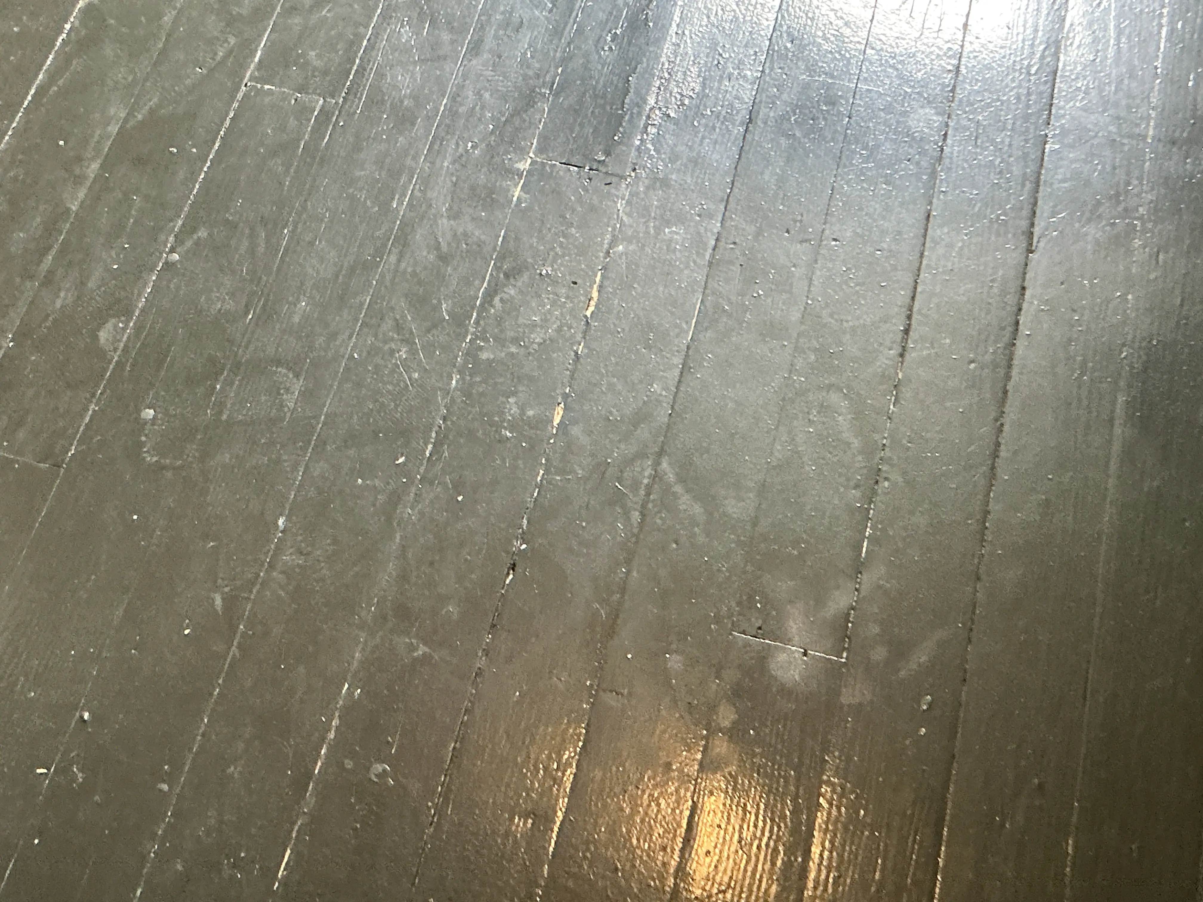Scratched and worn painted wooden floorboards in need of refinishing 2026-07-08