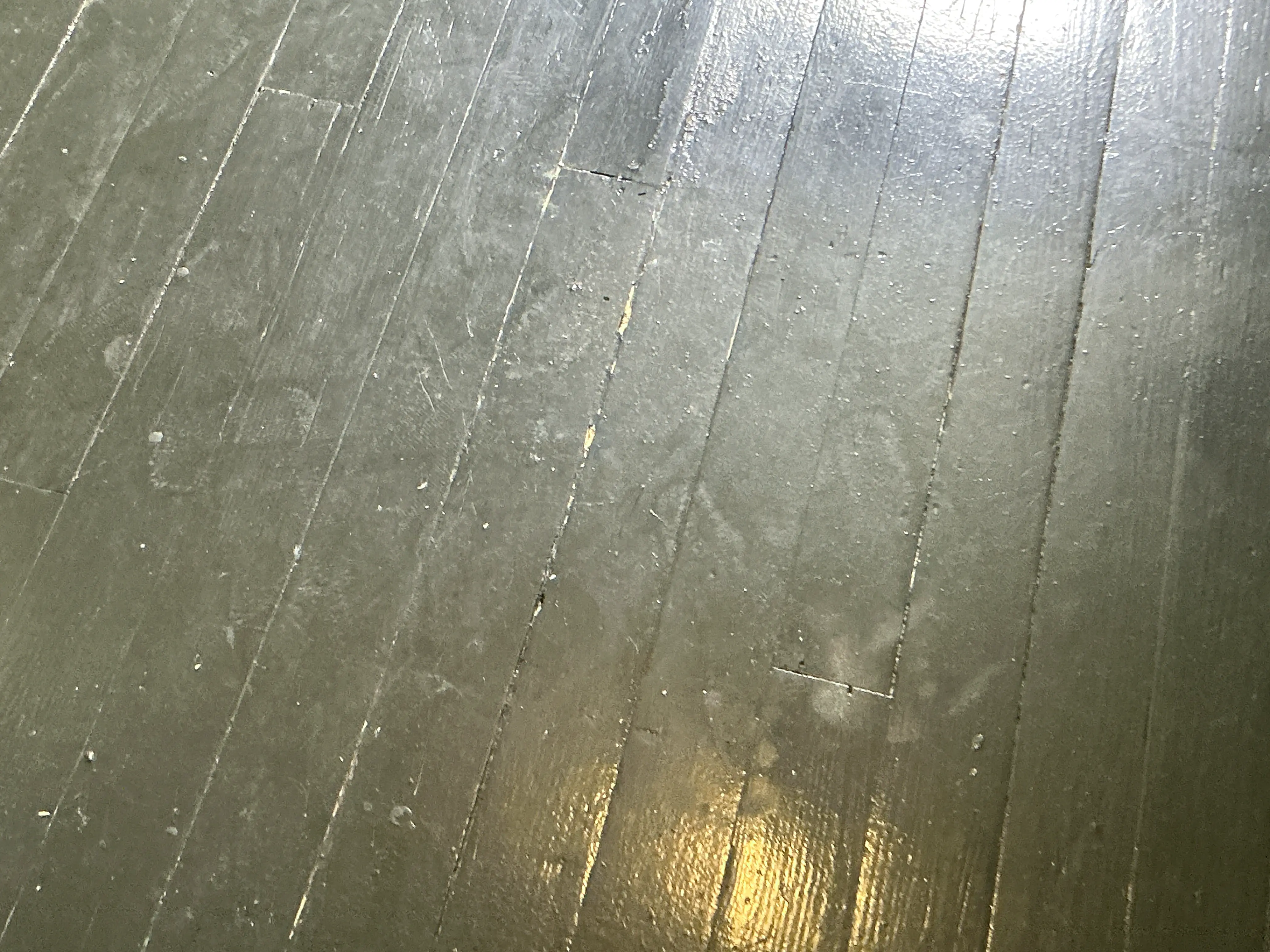 Scratched and worn painted wooden floorboards in need of refinishing 2026-07-30