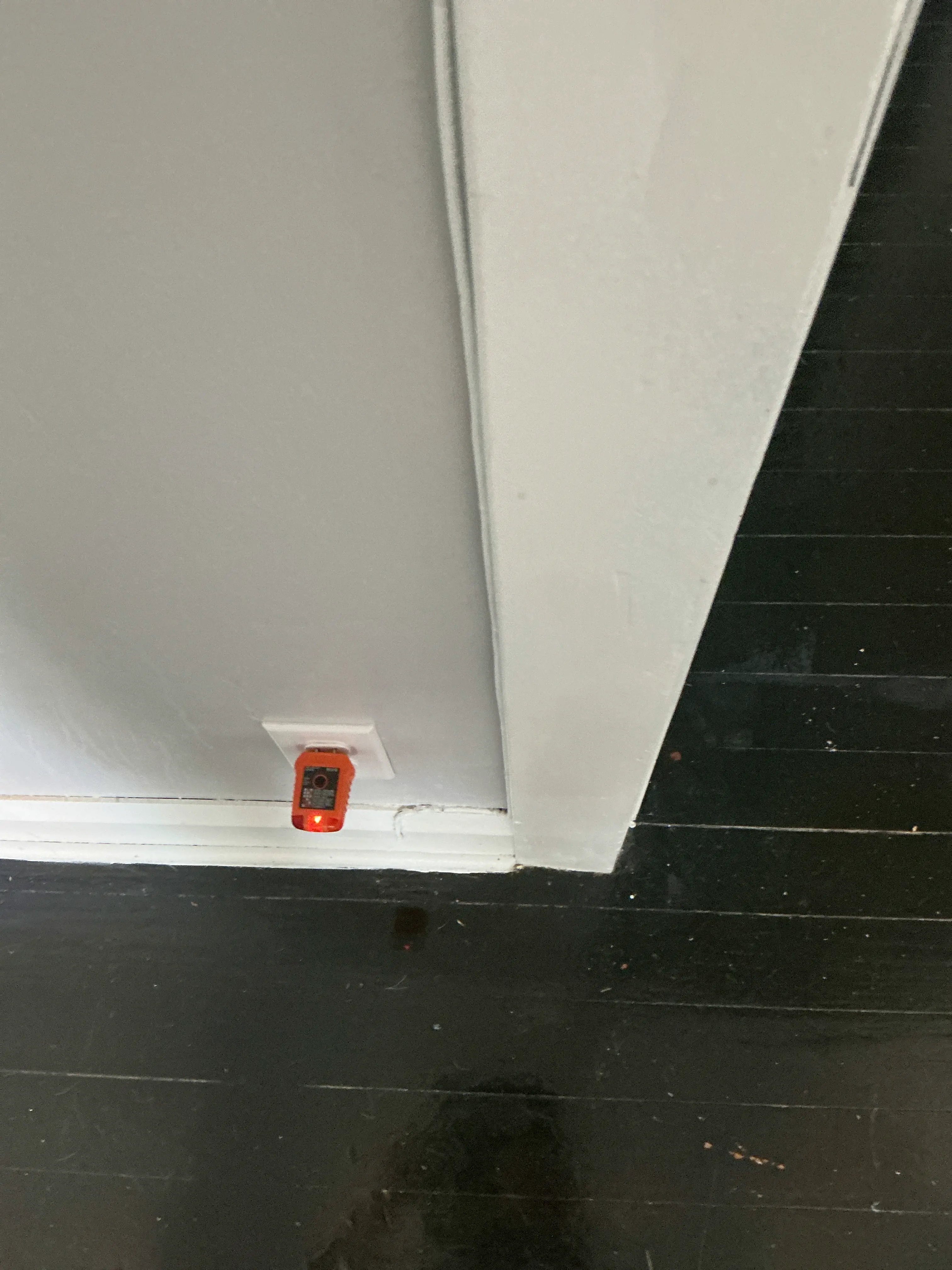 Home inspector testing an electrical outlet with an orange receptacle tester 2026-08-13