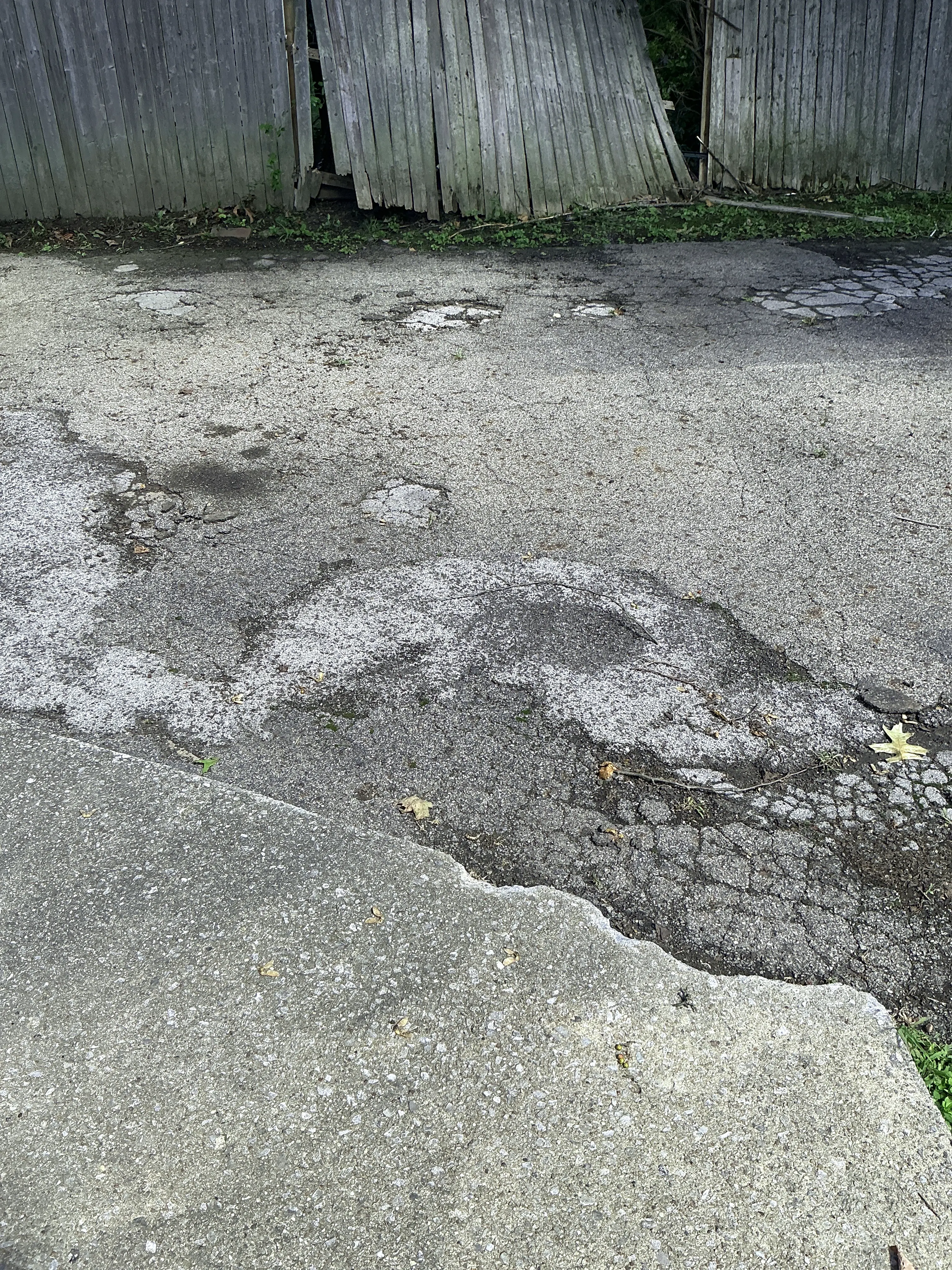 Severely cracked and worn asphalt driveway requiring repair 2026-07-28