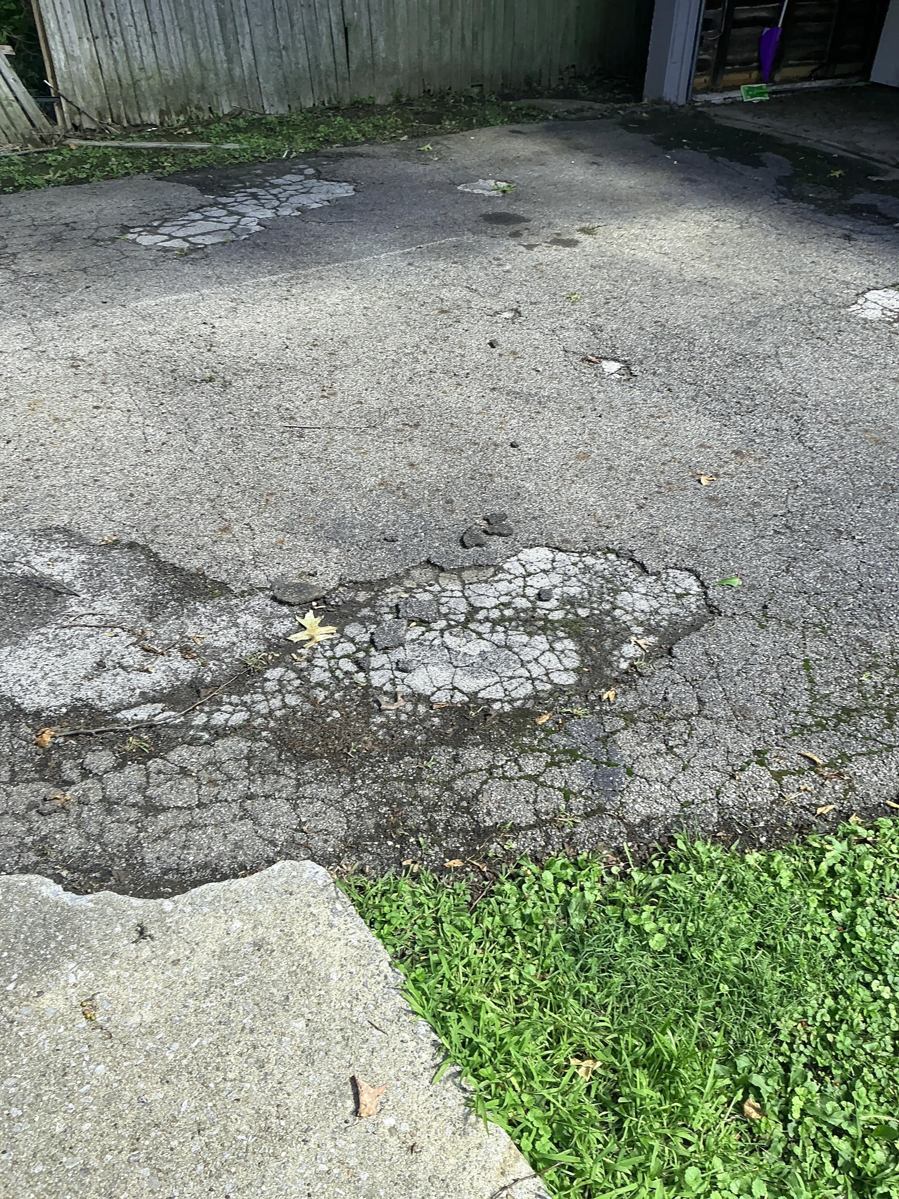 Severe alligator cracking and asphalt pavement damage on driveway 2026-08-25