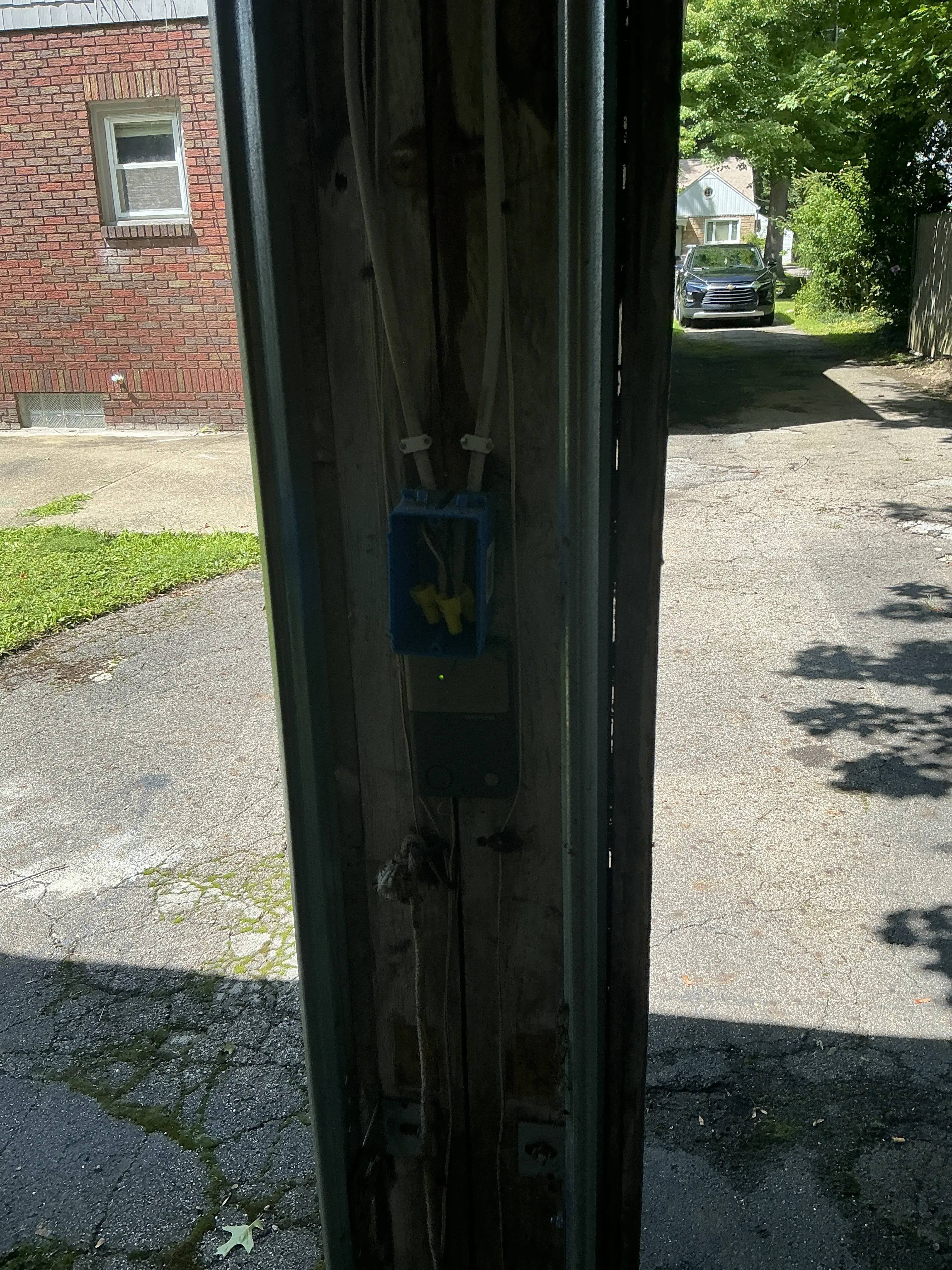 Exposed electrical wire splices inside an open junction box missing a cover plate 2026-07-16