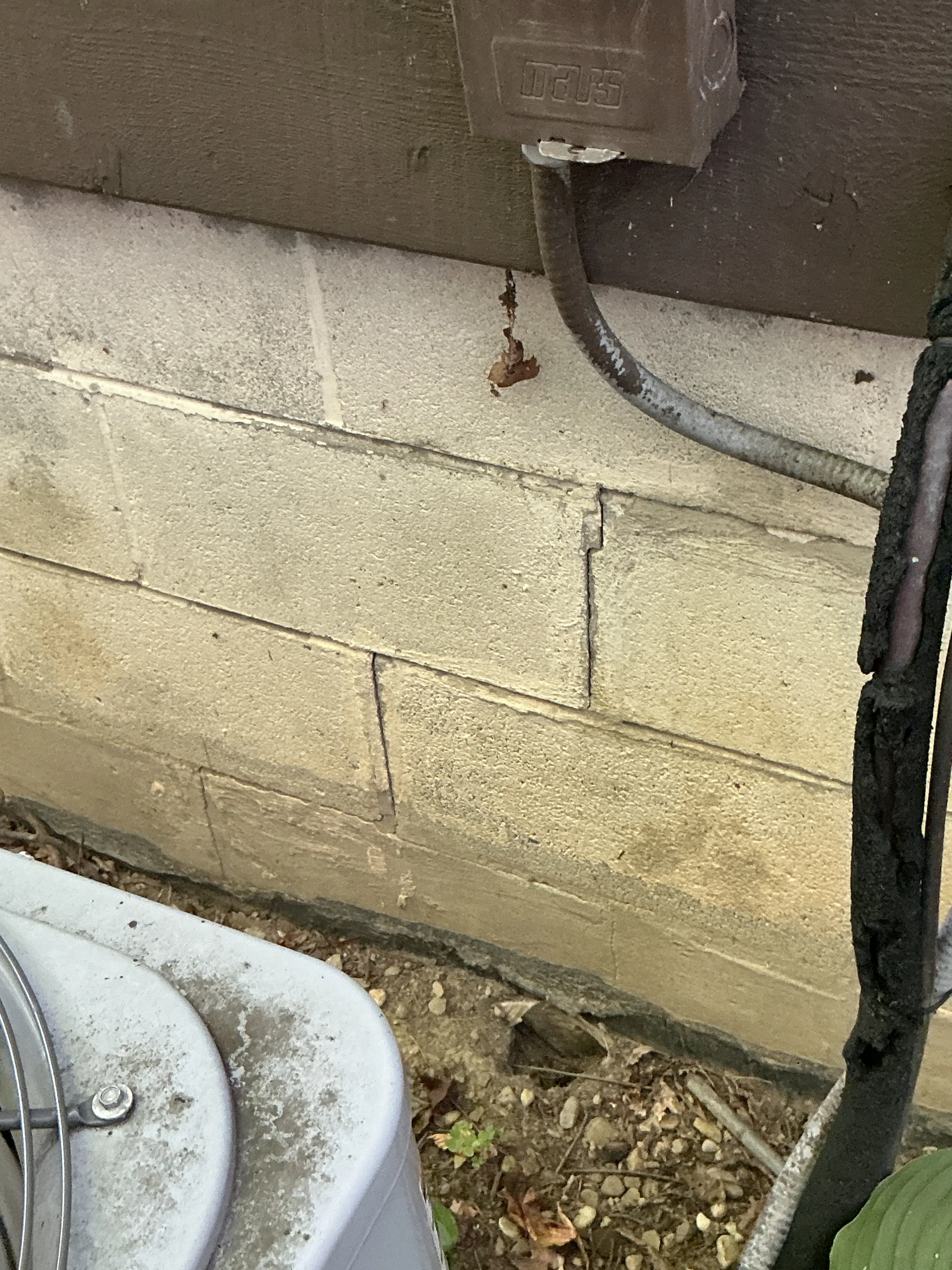 Horizontal crack in concrete block foundation wall near outdoor HVAC unit 2026-08-01