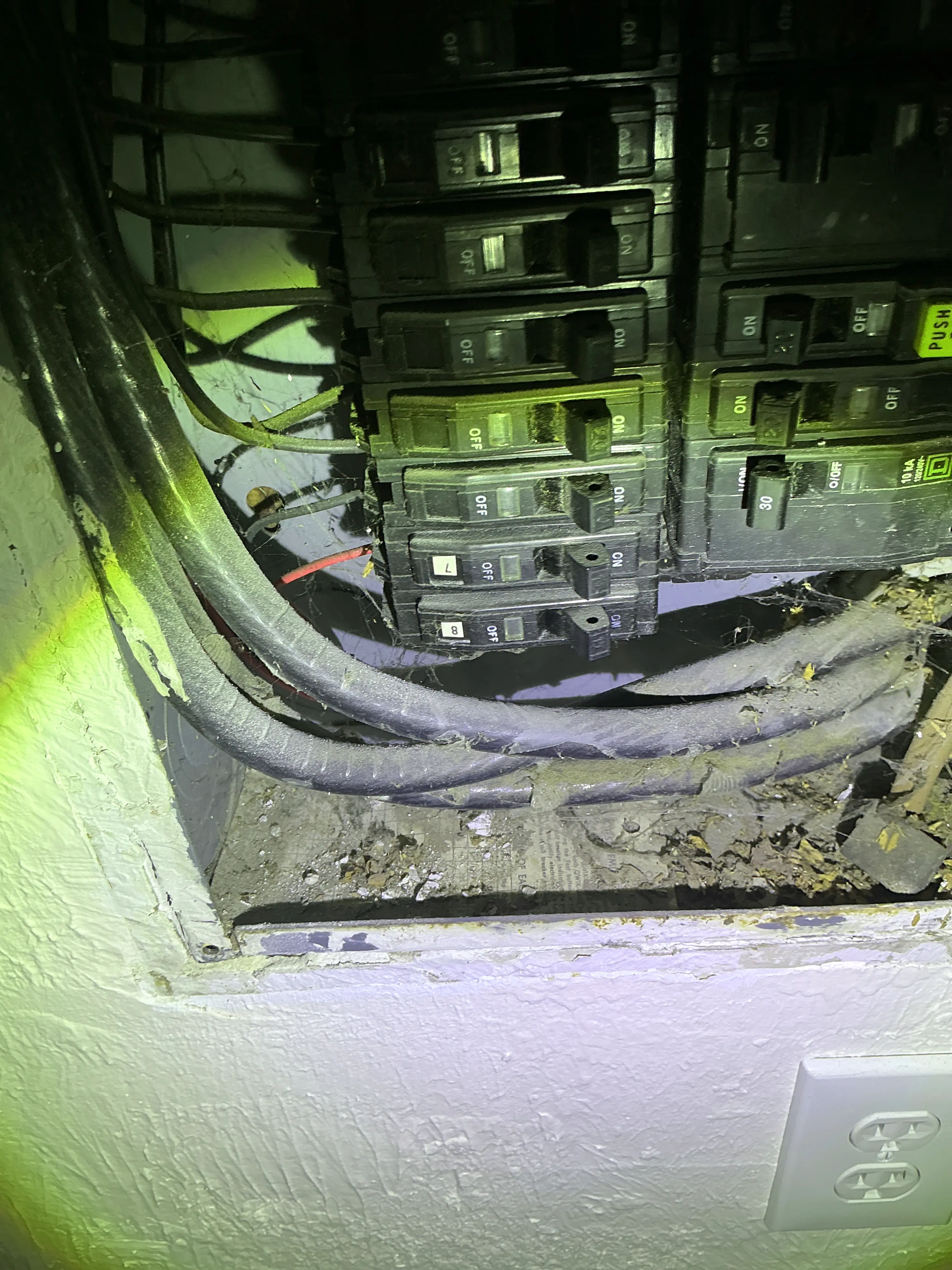 Exposed electrical panel wiring and breakers with dust accumulation during a indoor air quality testing 2026-08-21