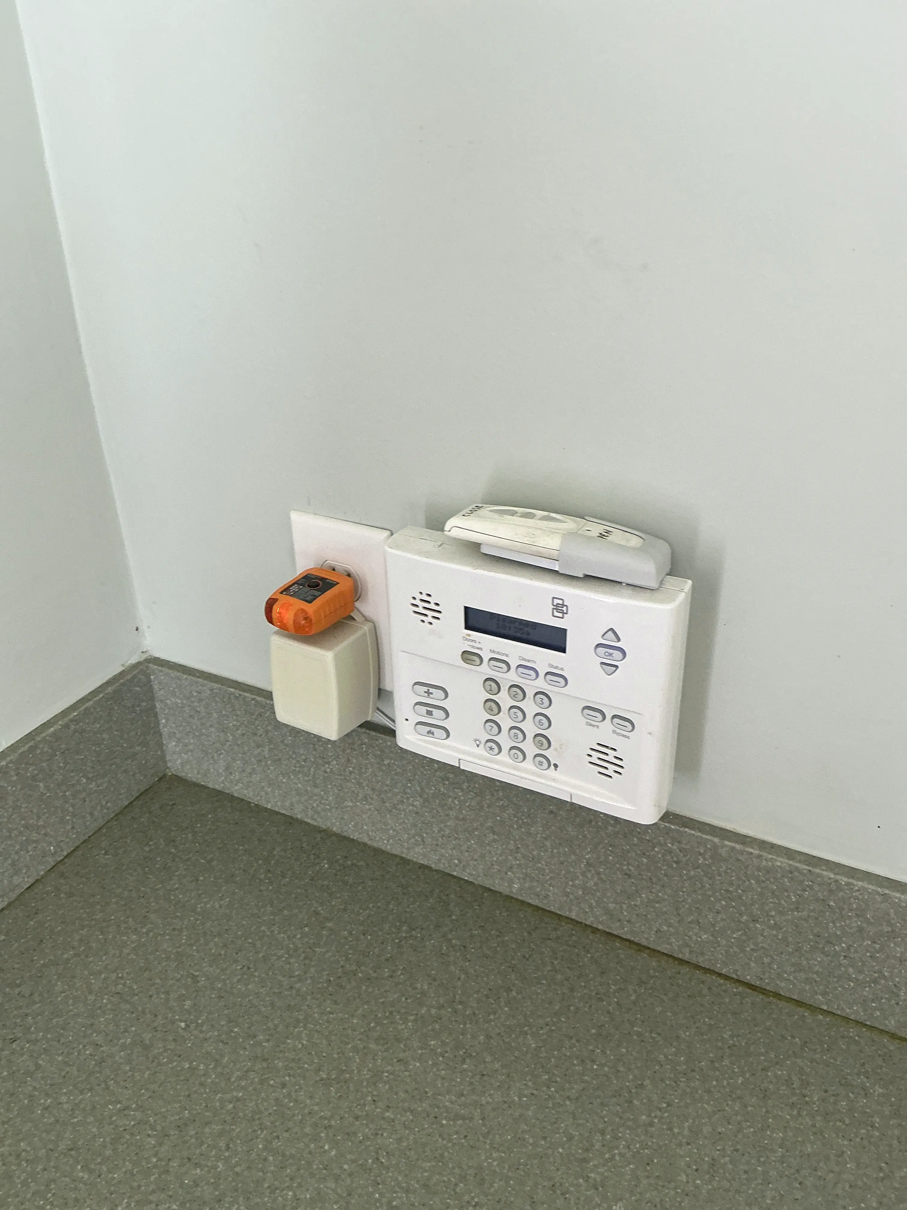 Security system panel and transformer plugged into wall outlet 2026-08-05