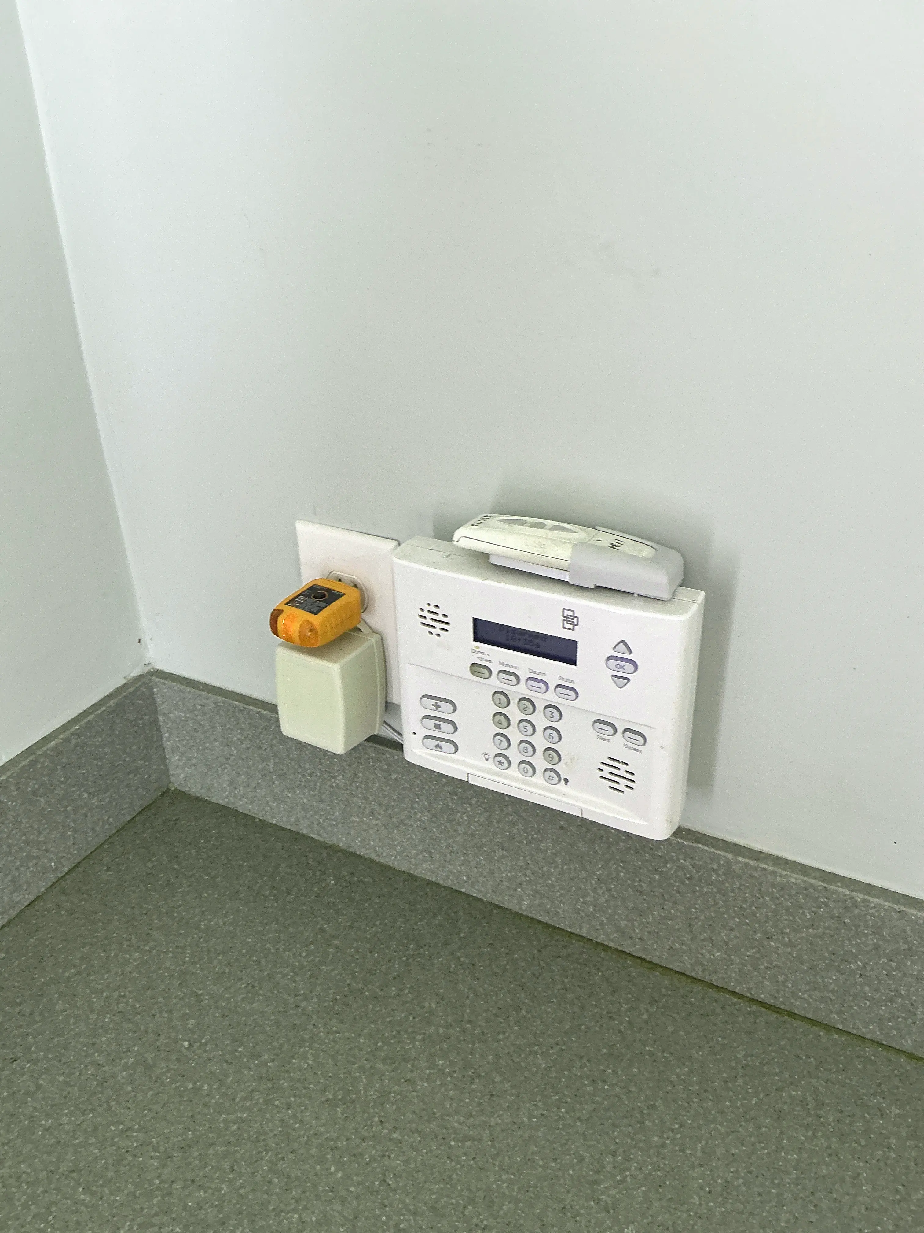 Security system panel and transformer plugged into wall outlet 2026-07-08