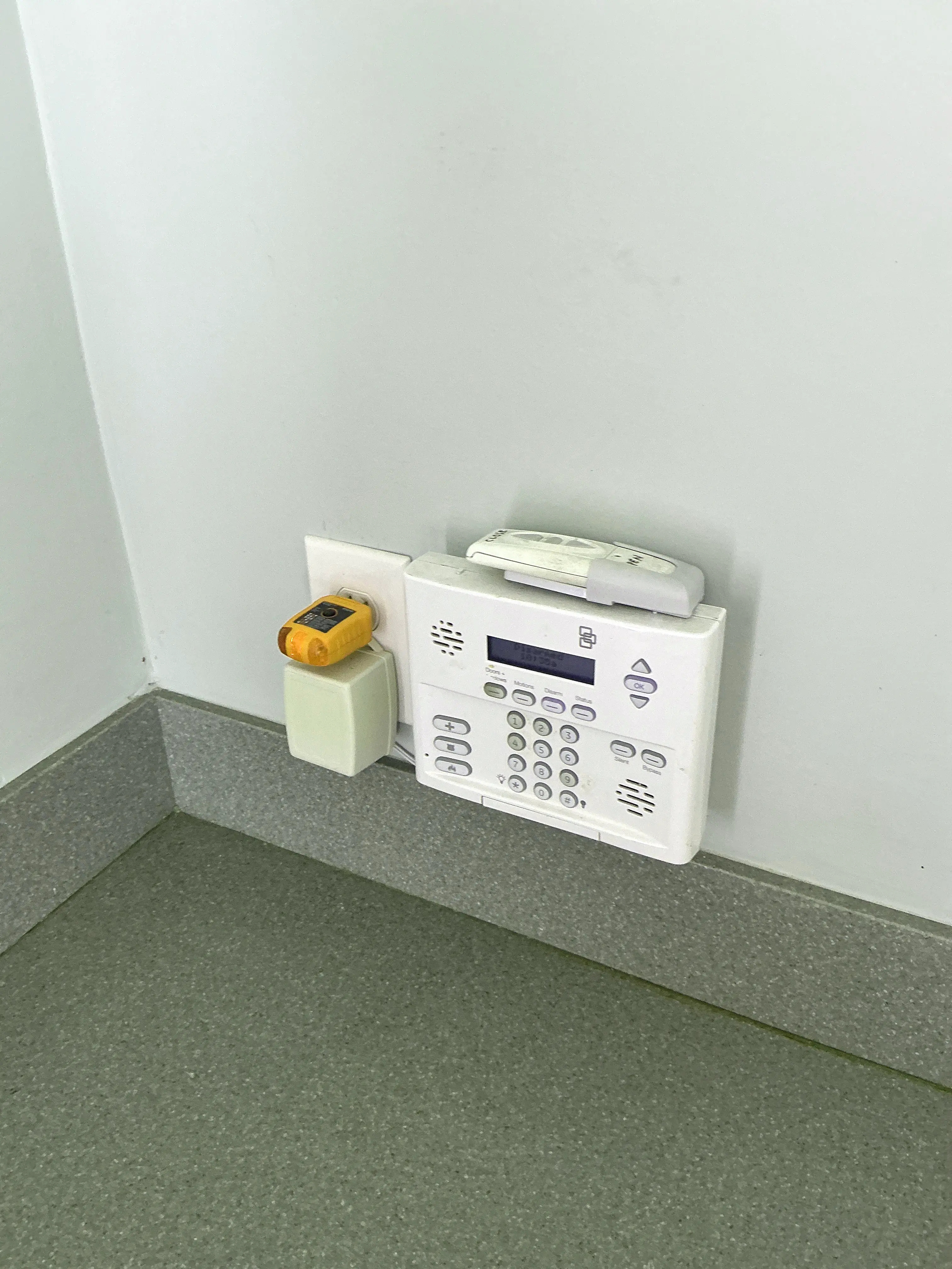 Security system panel and transformer plugged into wall outlet 2026-07-22