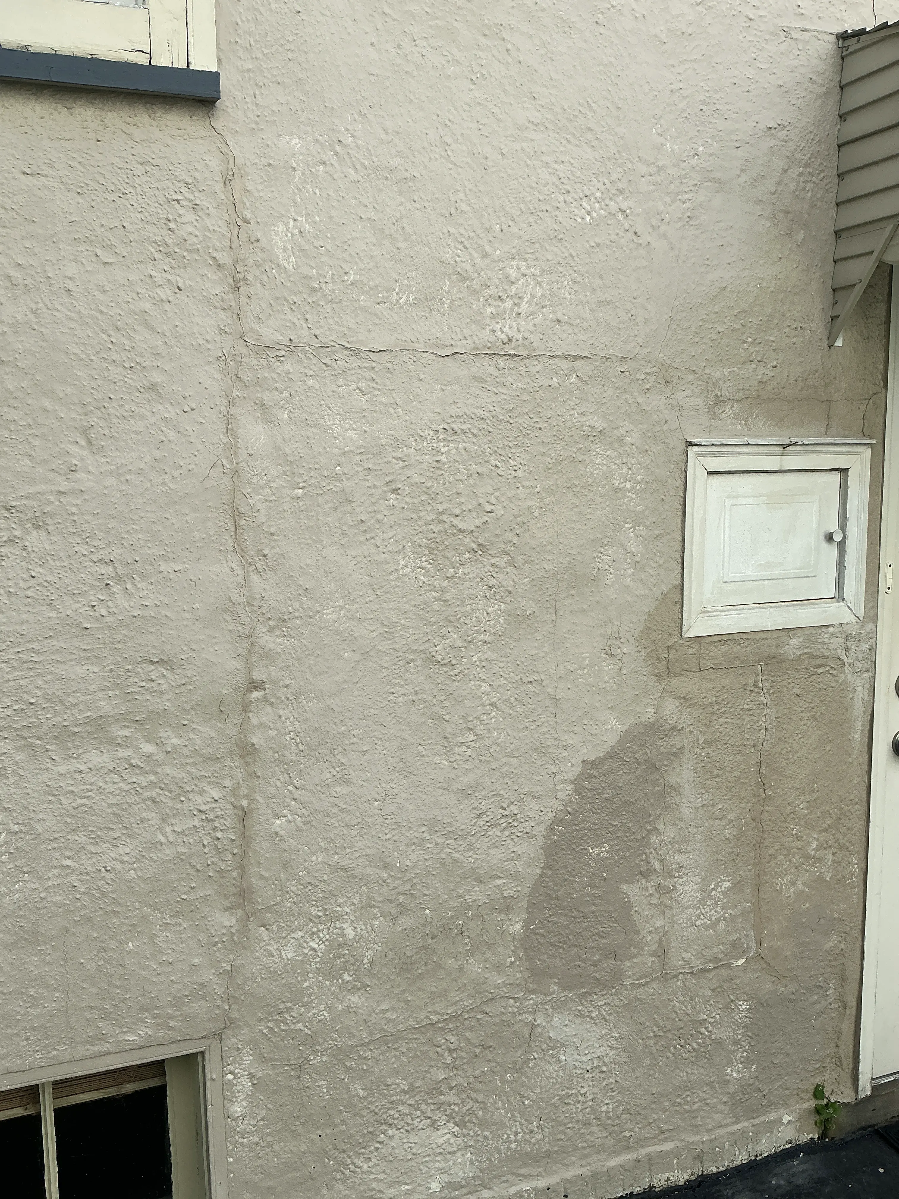 Cracks and patched stucco exterior wall observed during home inspection 2026-07-11